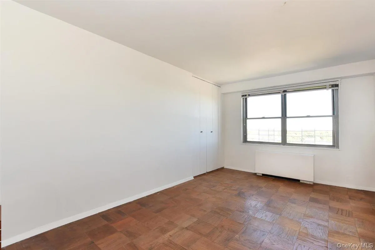 Empty room featuring radiator and baseboards Empty room featuring radiator and baseboards