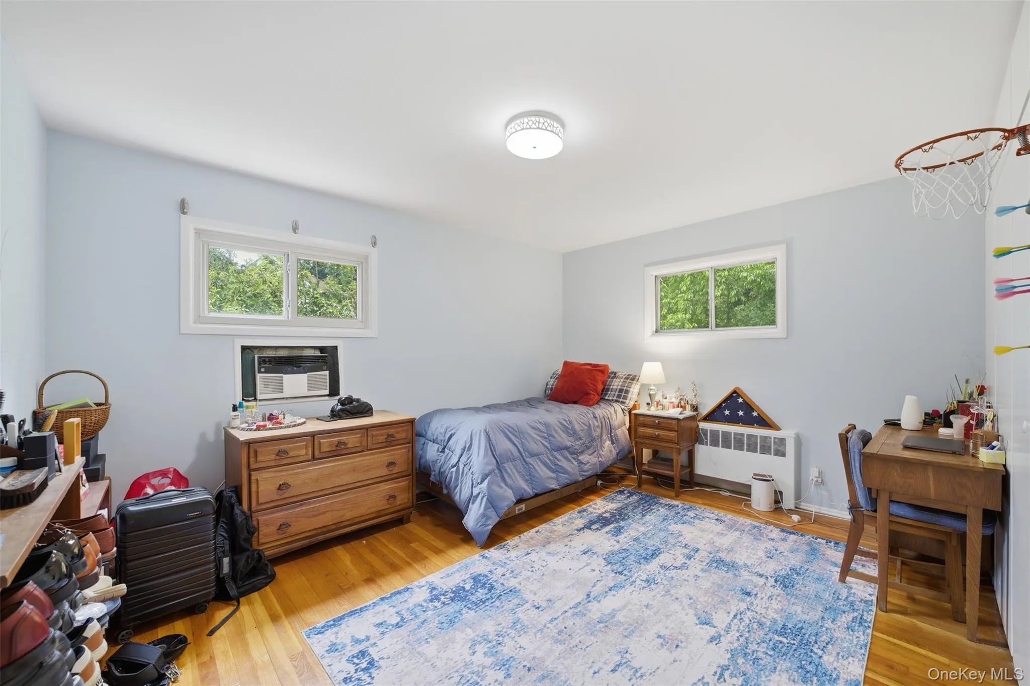 3rd Bedroom w/ Light blue walls complemented by wood-finish flooring 3rd Bedroom w/ Light blue walls complemented by wood-finish flooring