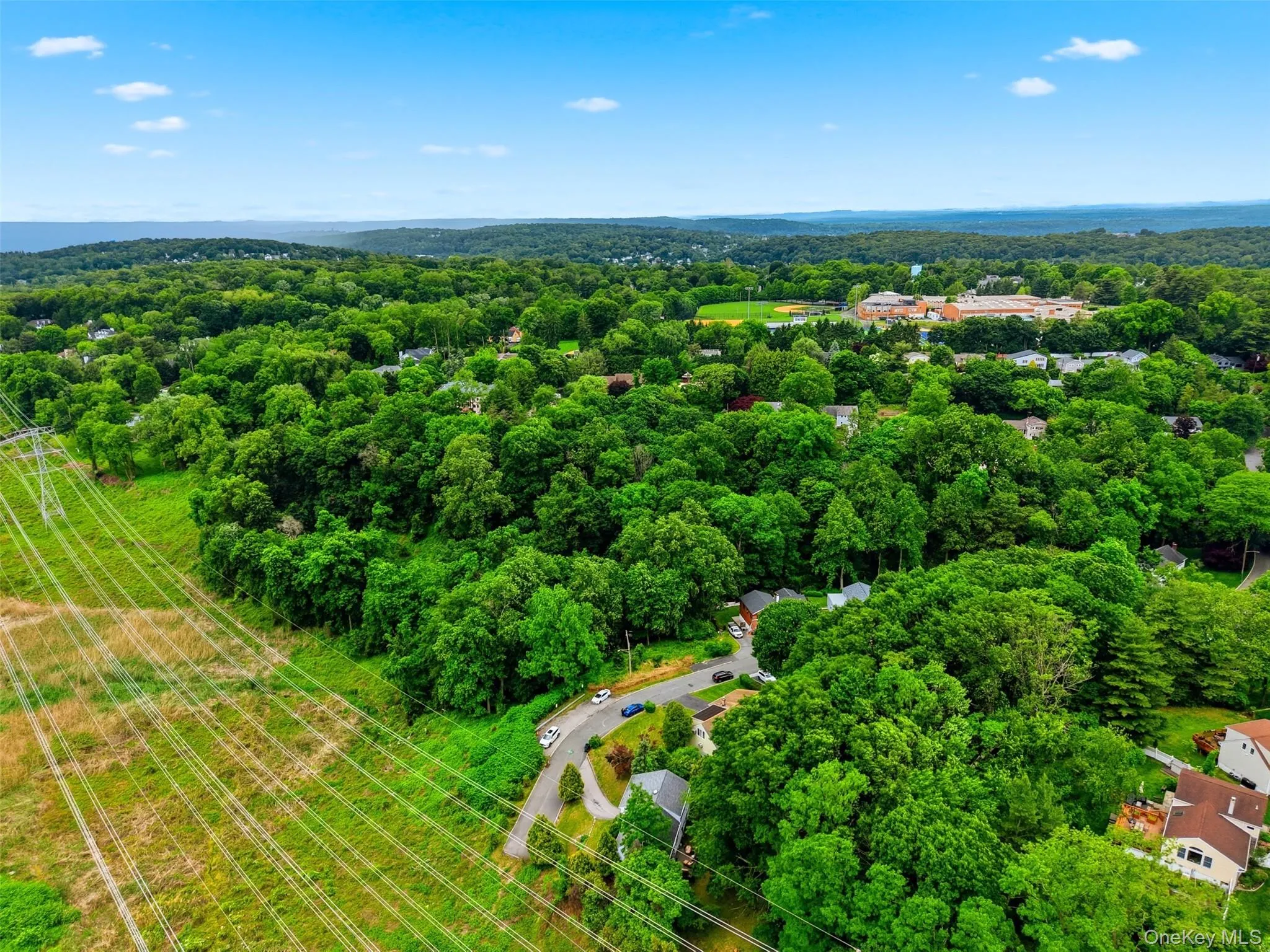 Close Proximity to High School -Expansive aerial perspective showcasing a verdant landscape with extensive tree canopy Close Proximity to High School -Expansive aerial perspective showcasing a verdant landscape with extensive tree canopy