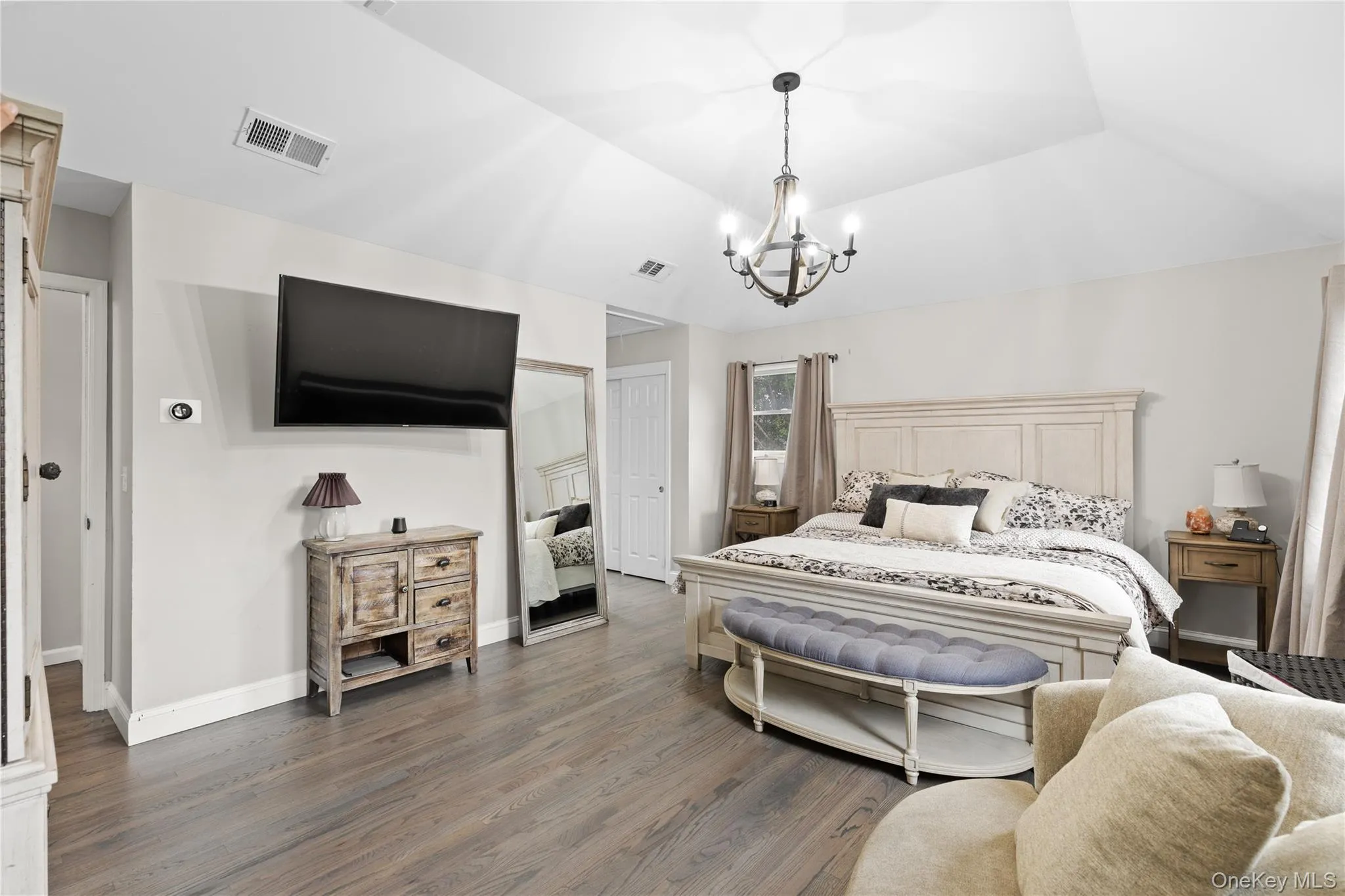 Spacious room with vaulted ceilings and wood-finish flooring Spacious room with vaulted ceilings and wood-finish flooring
