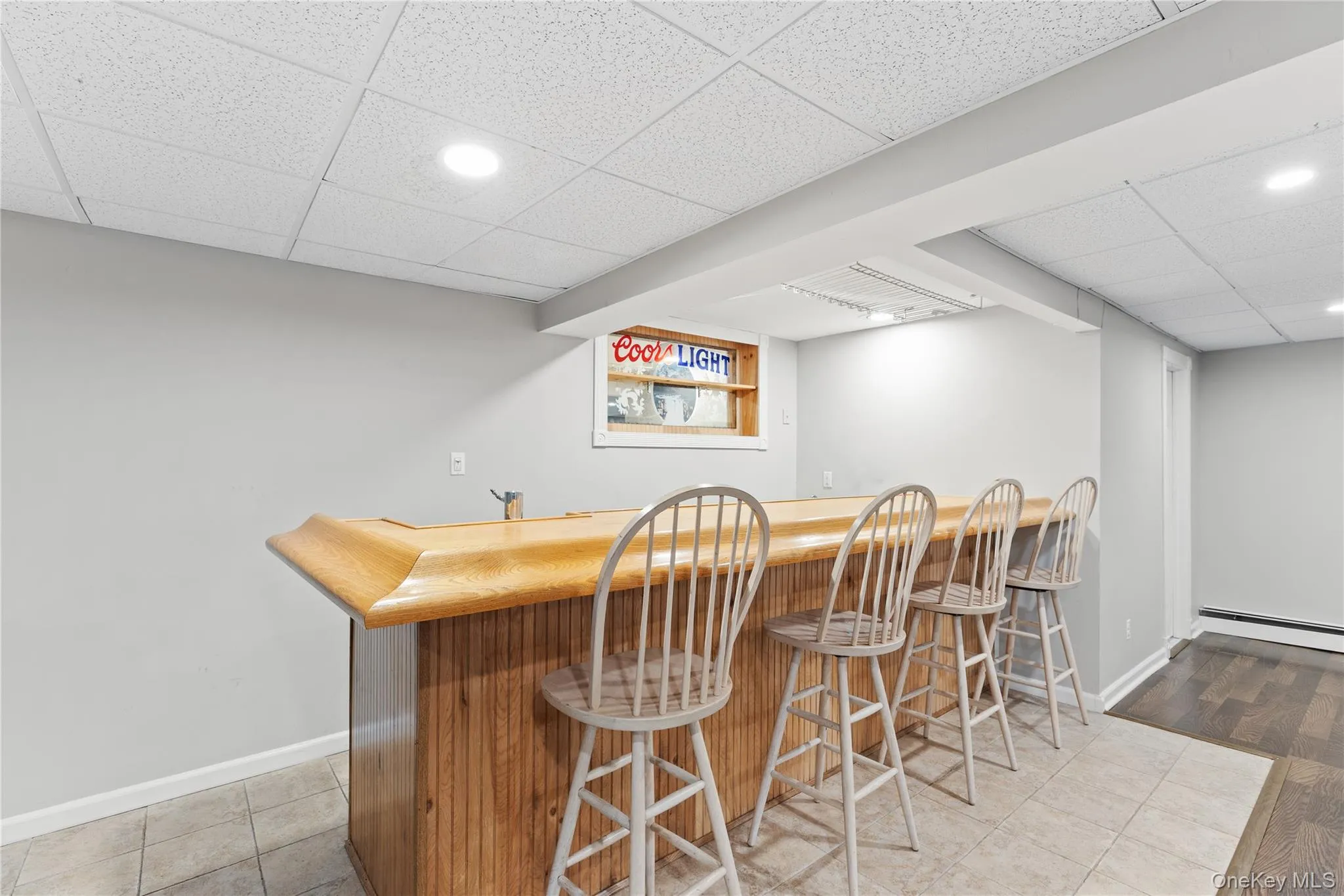 Custom bar featuring a wood-finish countertop and paneling Custom bar featuring a wood-finish countertop and paneling