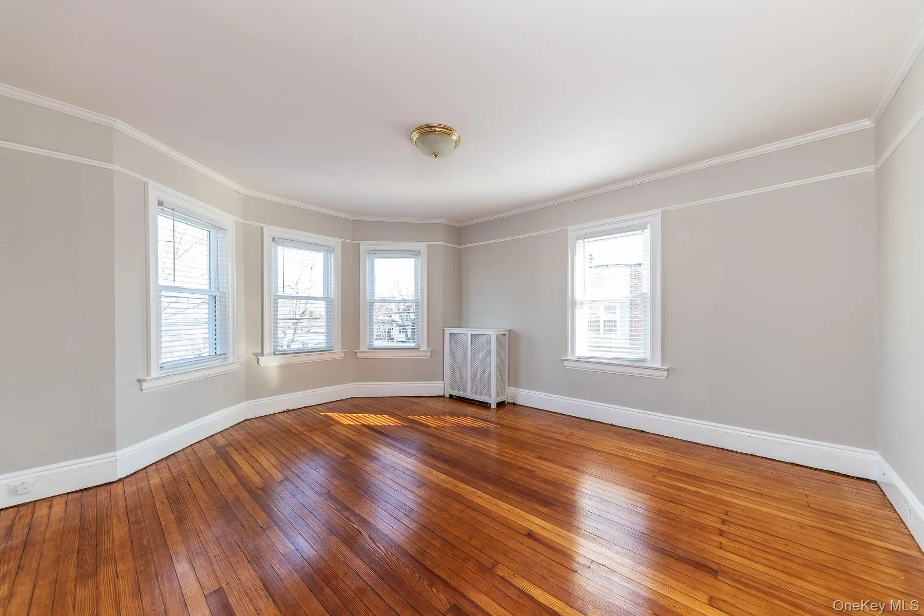 Bright and sunny oversized living room featuring beautiful natural light Bright and sunny oversized living room featuring beautiful natural light