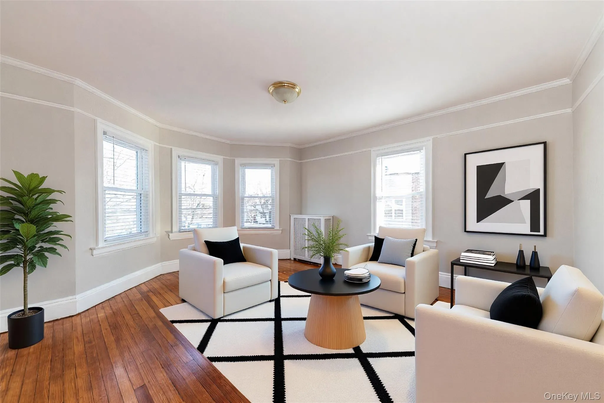 Bright and sunny oversized living room featuring beautiful natural light (Staged) Bright and sunny oversized living room featuring beautiful natural light (Staged)