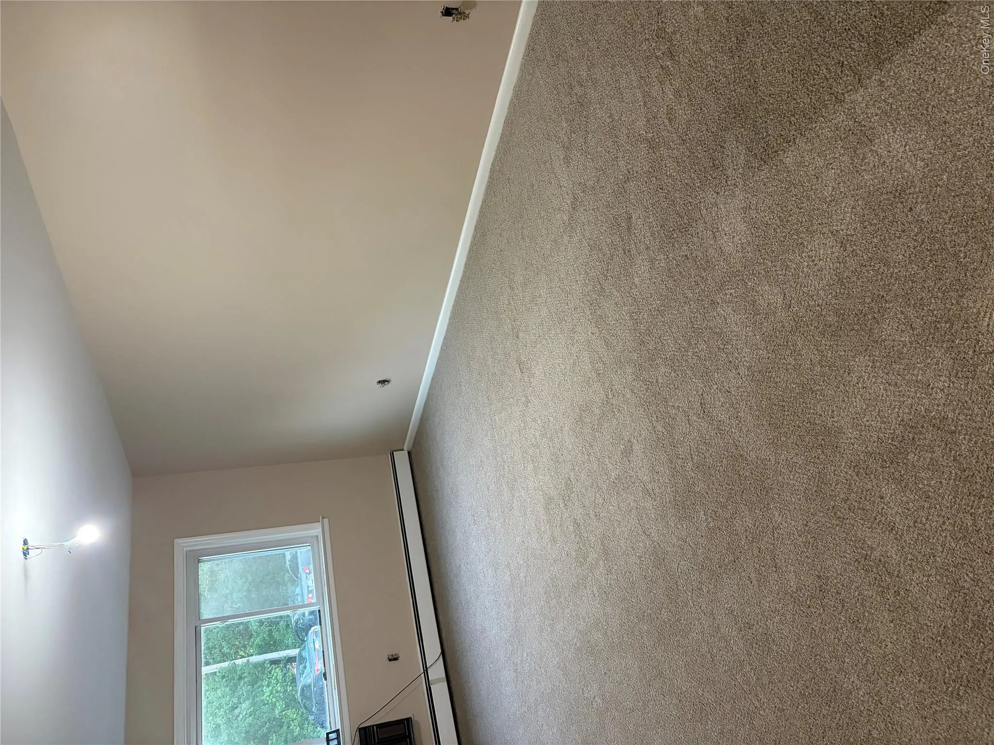 Living room with wall unit ac and new carpeting Living room with wall unit ac and new carpeting