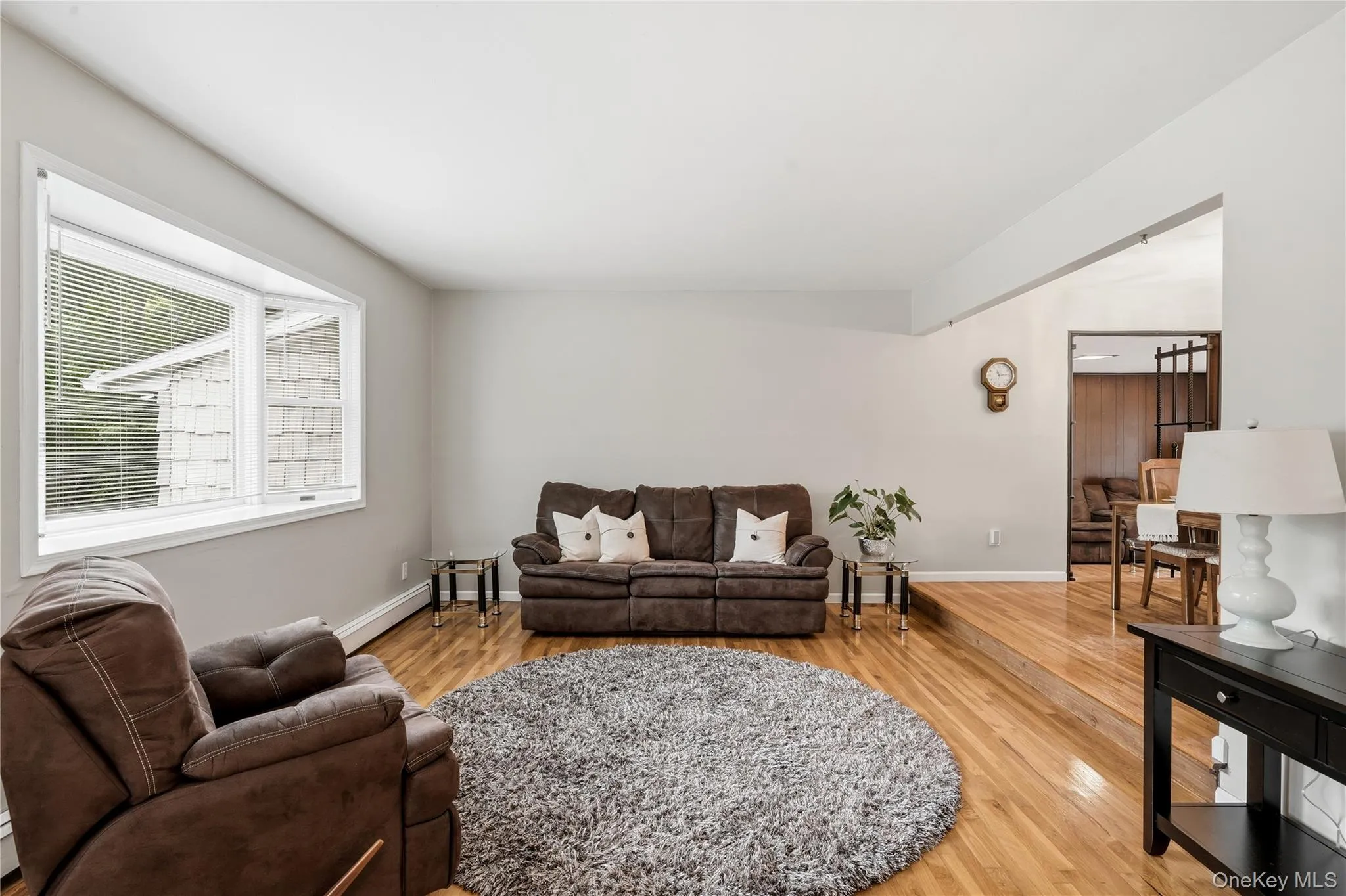 Sunken Living Room with Bay Window and Hardwood Floors Sunken Living Room with Bay Window and Hardwood Floors