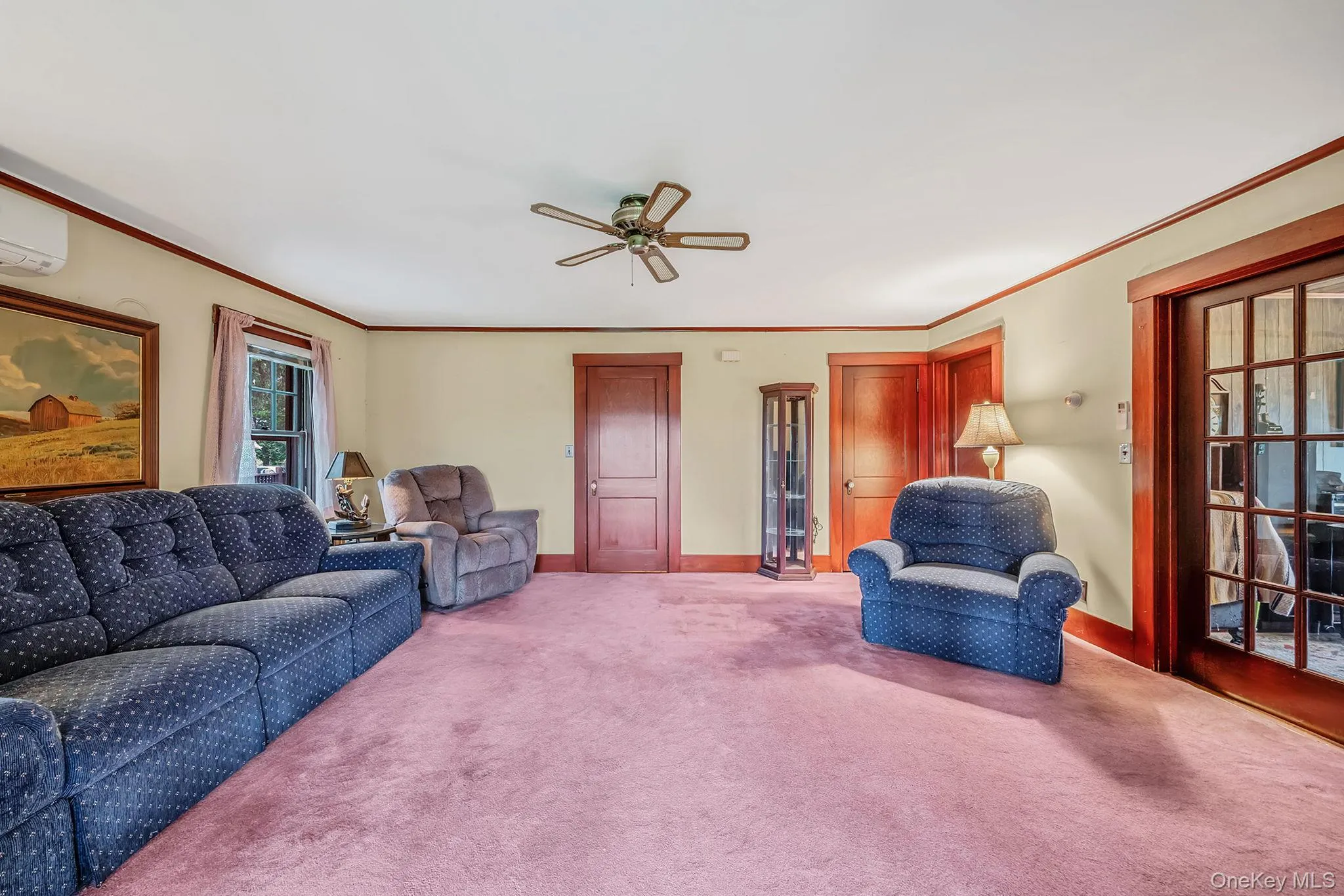 Room featuring a ceiling fan, wall-mounted Split Unit, and a window. Room featuring a ceiling fan, wall-mounted Split Unit, and a window.