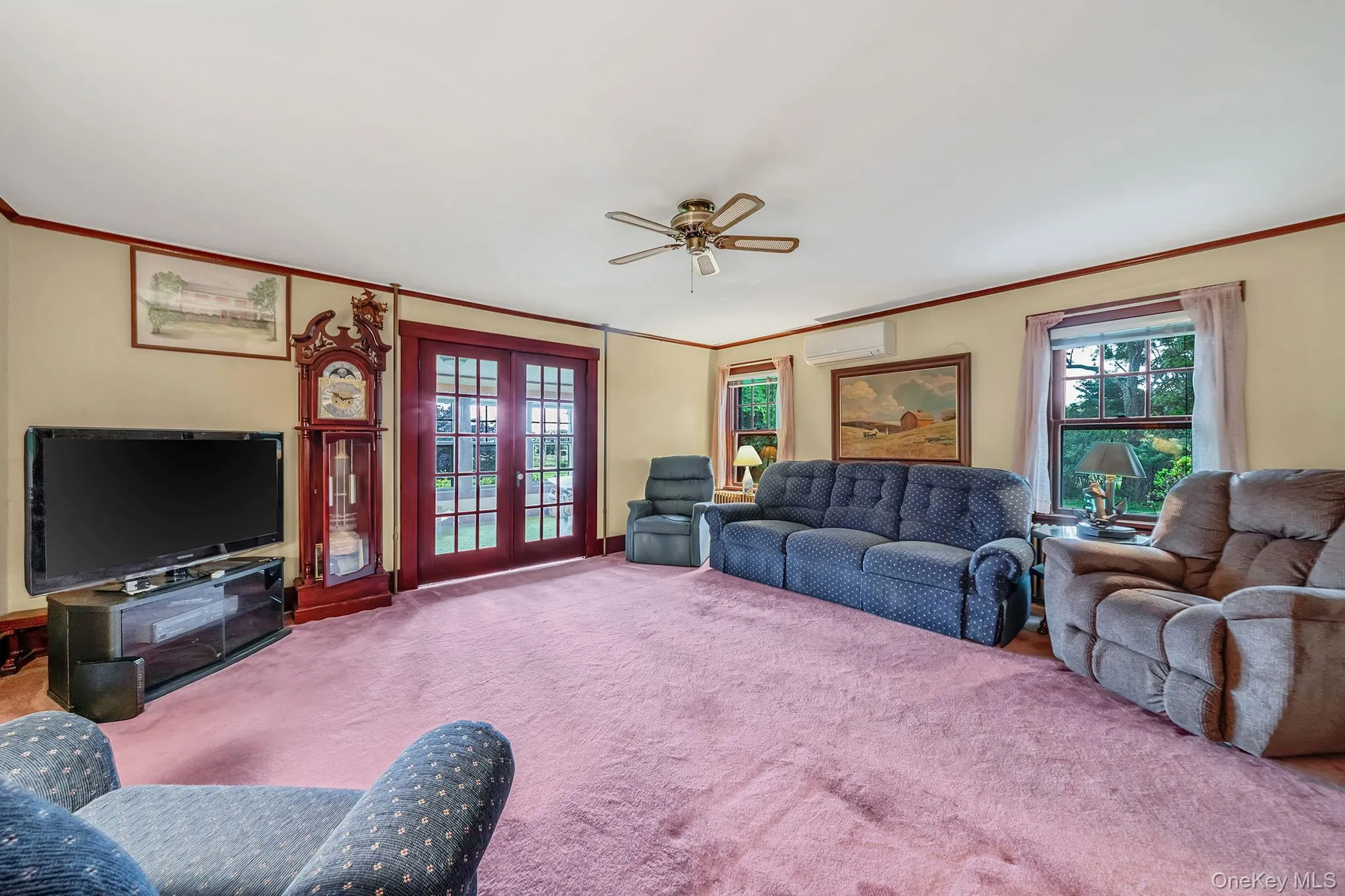 Spacious interior room featuring light-colored walls, wood trim, and a ceiling fan. French Doors to Parlor Spacious interior room featuring light-colored walls, wood trim, and a ceiling fan. French Doors to Parlor
