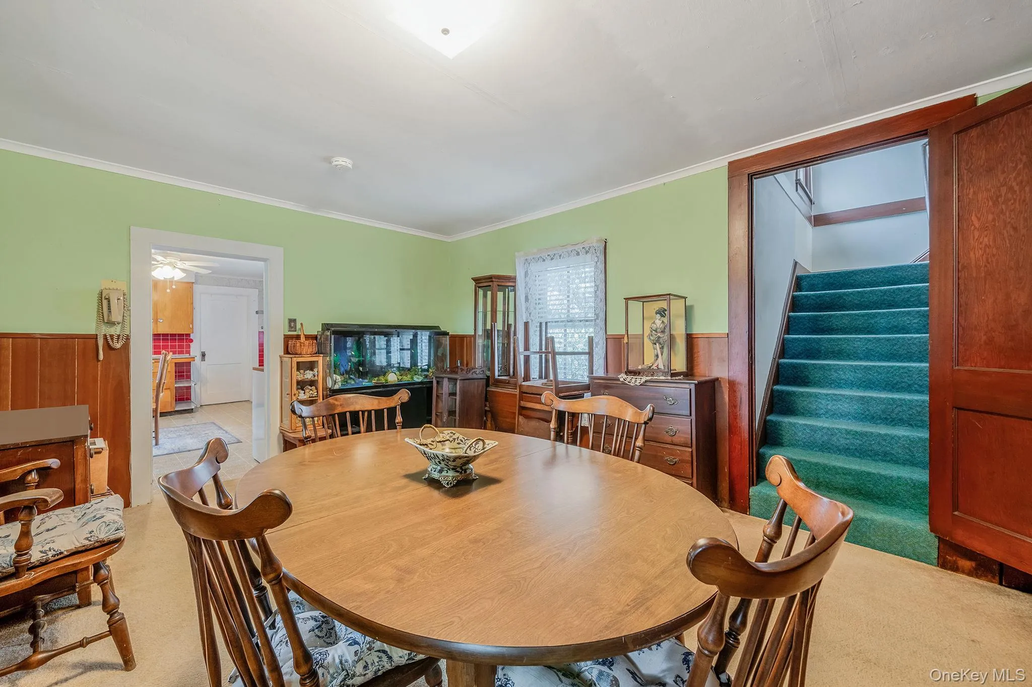 Dining area featuring wood-finish wainscoting,, and carpeting Dining area featuring wood-finish wainscoting,, and carpeting