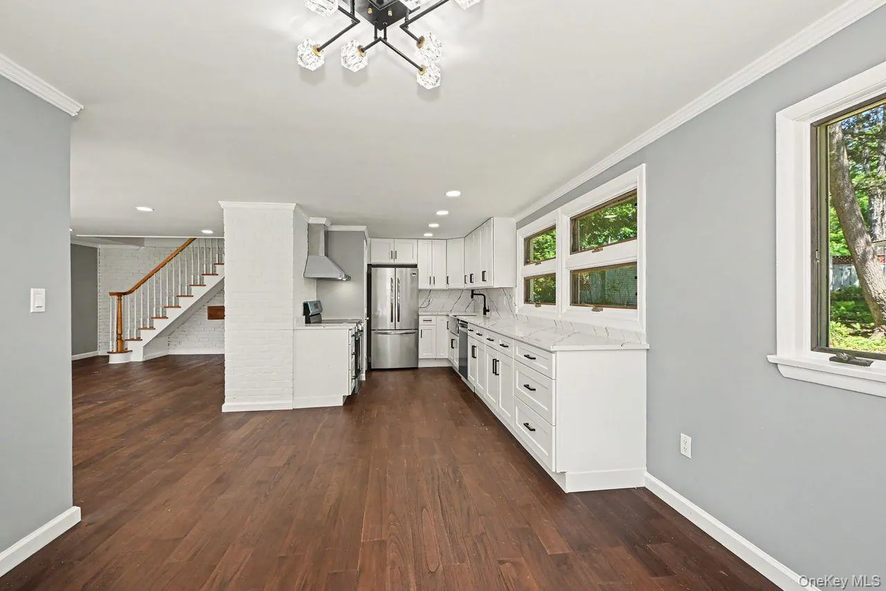 View from dining room into kitchen and living room on left. View from dining room into kitchen and living room on left.