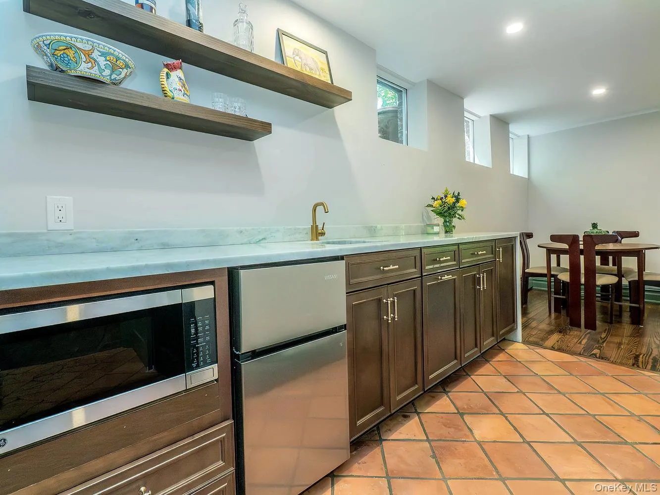 Partial Kitchen with Small Refrigerator, freezer, Microwave and Sink. Marble Countertop Partial Kitchen with Small Refrigerator, freezer, Microwave and Sink. Marble Countertop