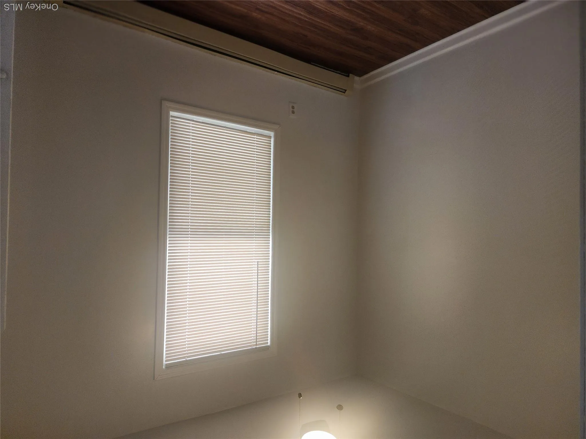 bedroom featuring a single window with blinds, wood-finish flooring, white baseboards, and a ceiling fan with integrated lighting bedroom featuring a single window with blinds, wood-finish flooring, white baseboards, and a ceiling fan with integrated lighting