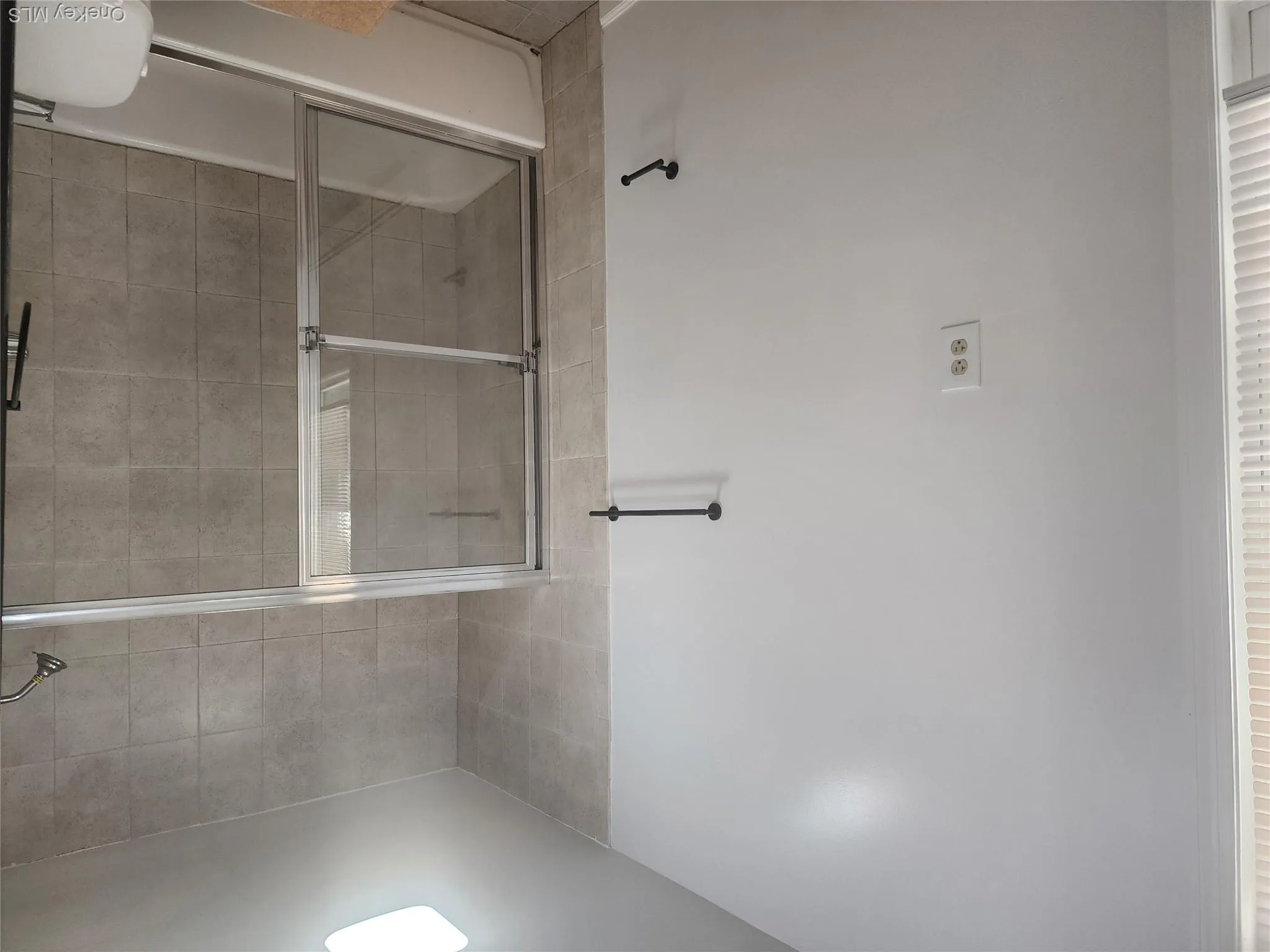 Tub and shower combination featuring sliding glass doors Tub and shower combination featuring sliding glass doors