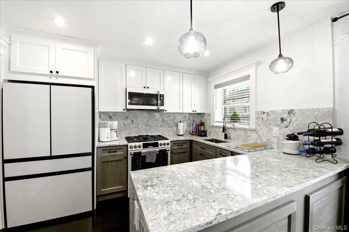 Kitchen with Quartz countertops and modern appliances Kitchen with Quartz countertops and modern appliances