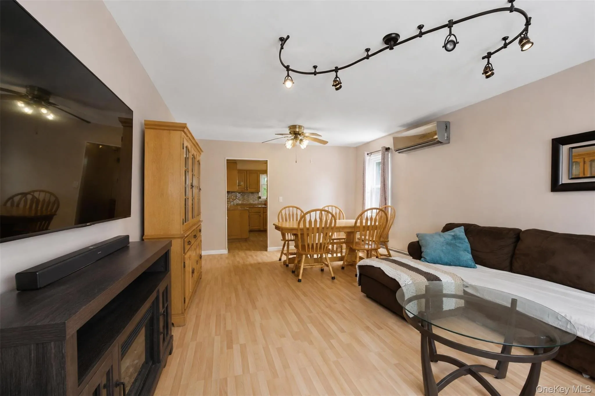 Open-concept living space featuring light wood-finish flooring, recessed lighting, and a ceiling fan Open-concept living space featuring light wood-finish flooring, recessed lighting, and a ceiling fan