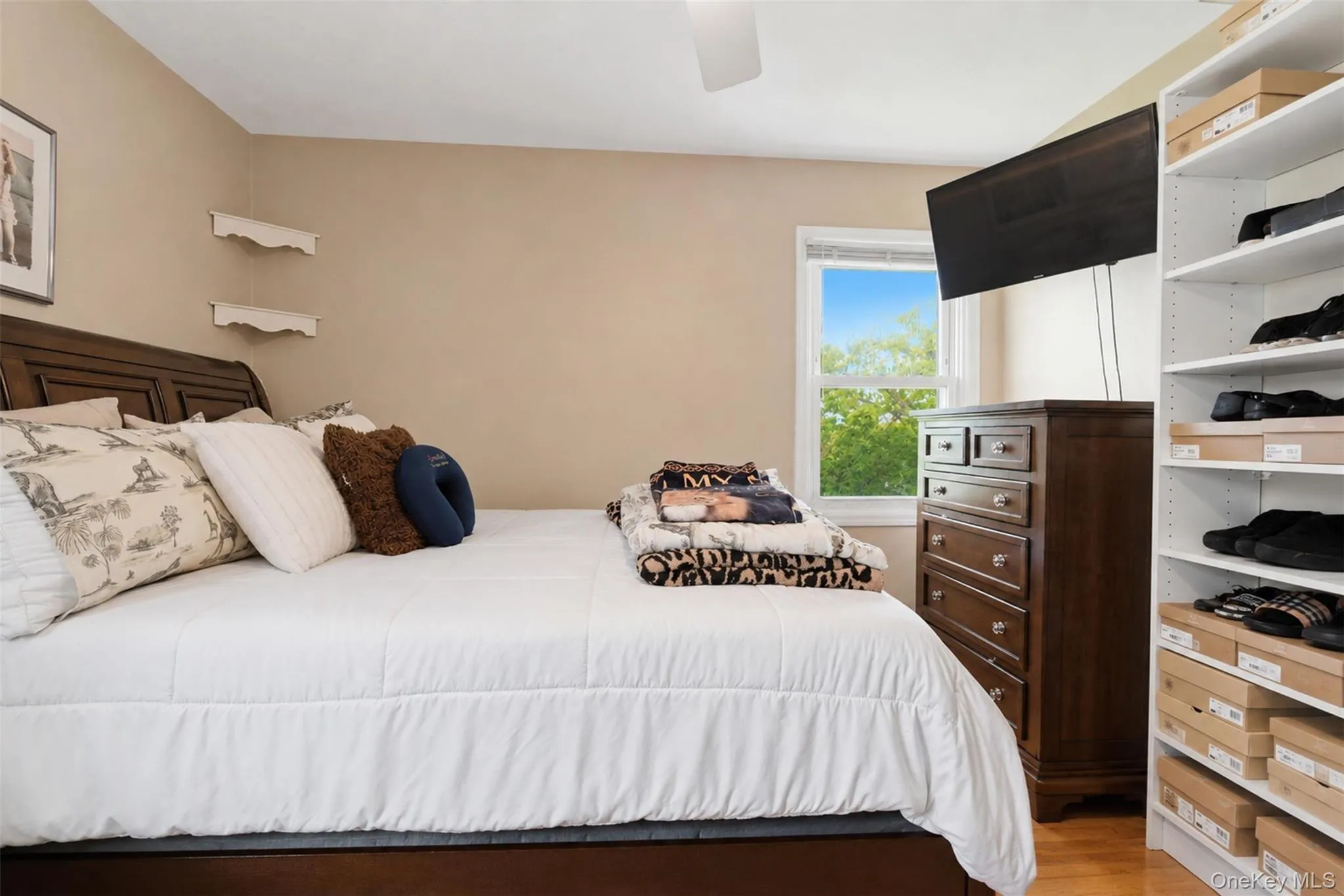 Bedroom with neutral wall tones and light-toned wood-finish flooring Bedroom with neutral wall tones and light-toned wood-finish flooring