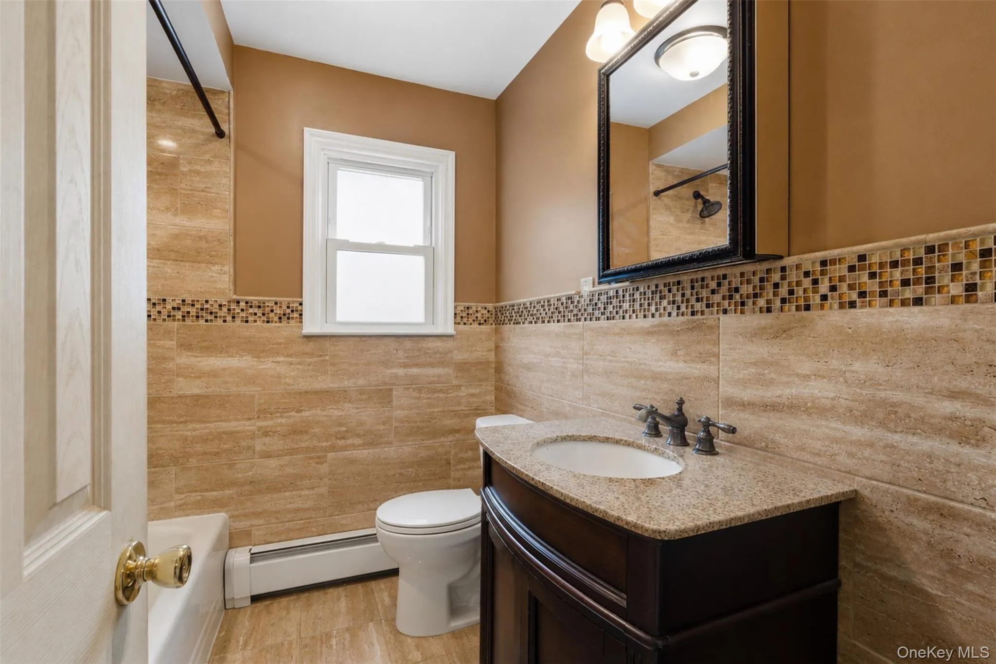 Bathroom featuring a dark wood vanity with a light speckled countertop and undermount sink Bathroom featuring a dark wood vanity with a light speckled countertop and undermount sink