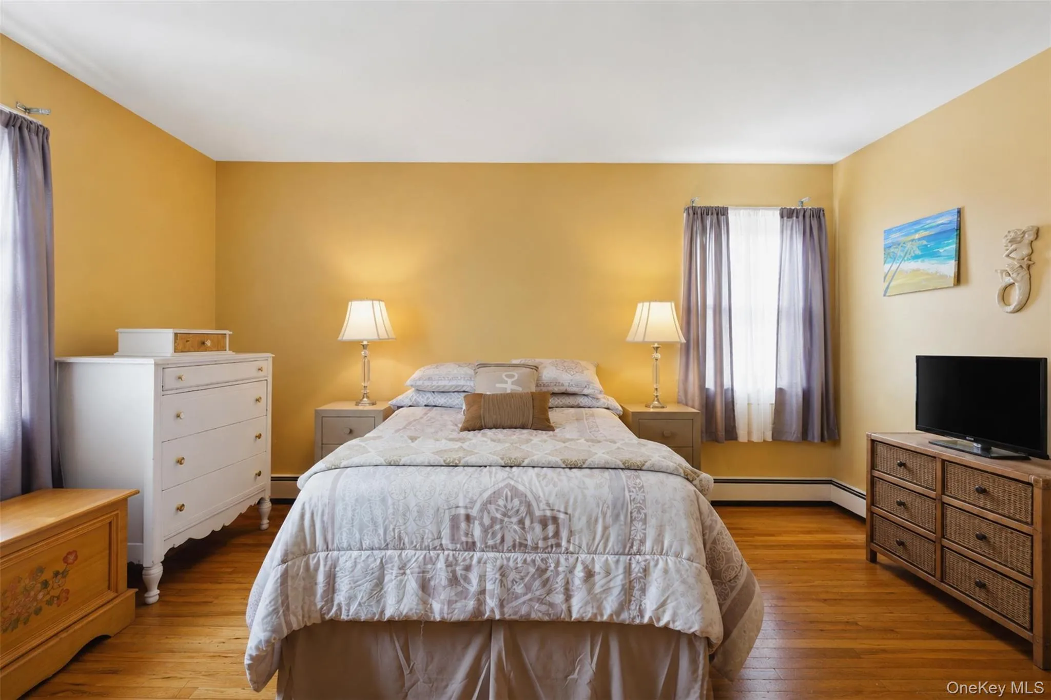 Room with wood-finish flooring, a window with curtain rods, and baseboard trim Room with wood-finish flooring, a window with curtain rods, and baseboard trim