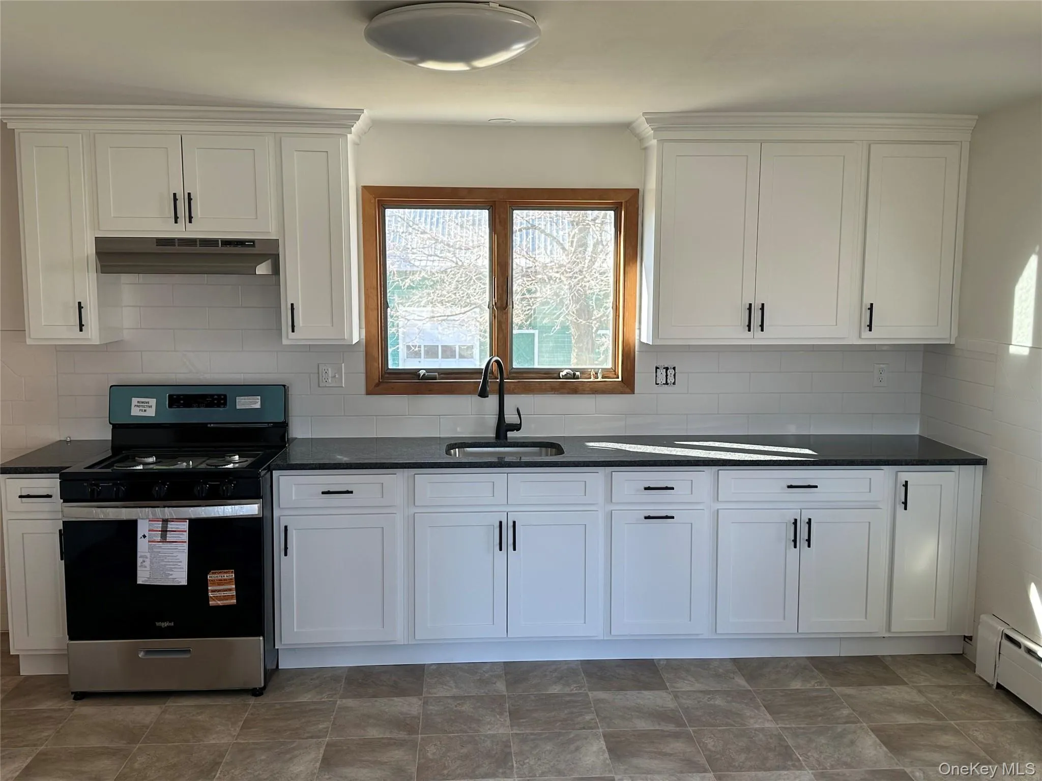 Newly renovated Kitchen with updated cabinets and stove. Newly renovated Kitchen with updated cabinets and stove.