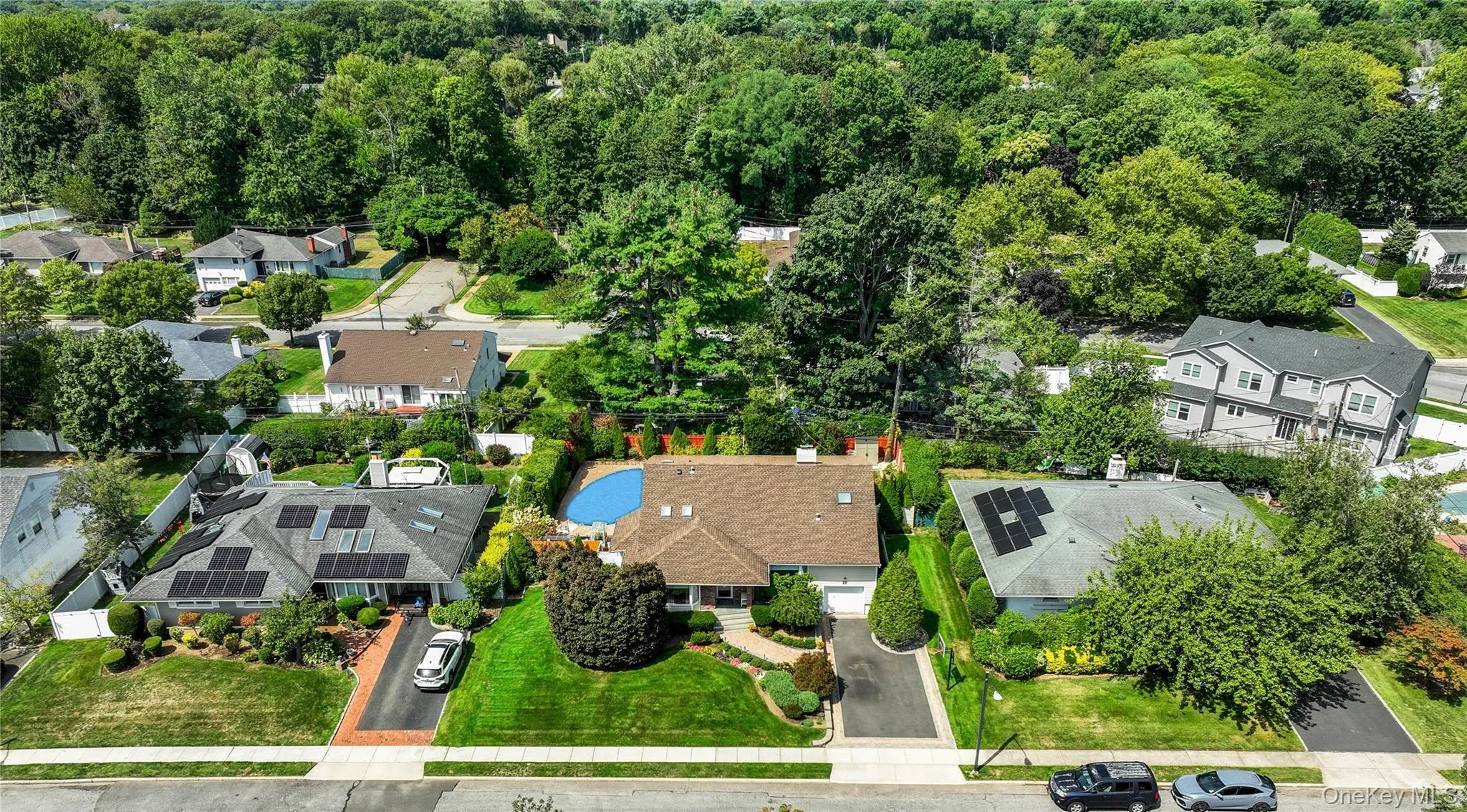 Aerial view of residential area featuring a heavily wooded area Aerial view of residential area featuring a heavily wooded area