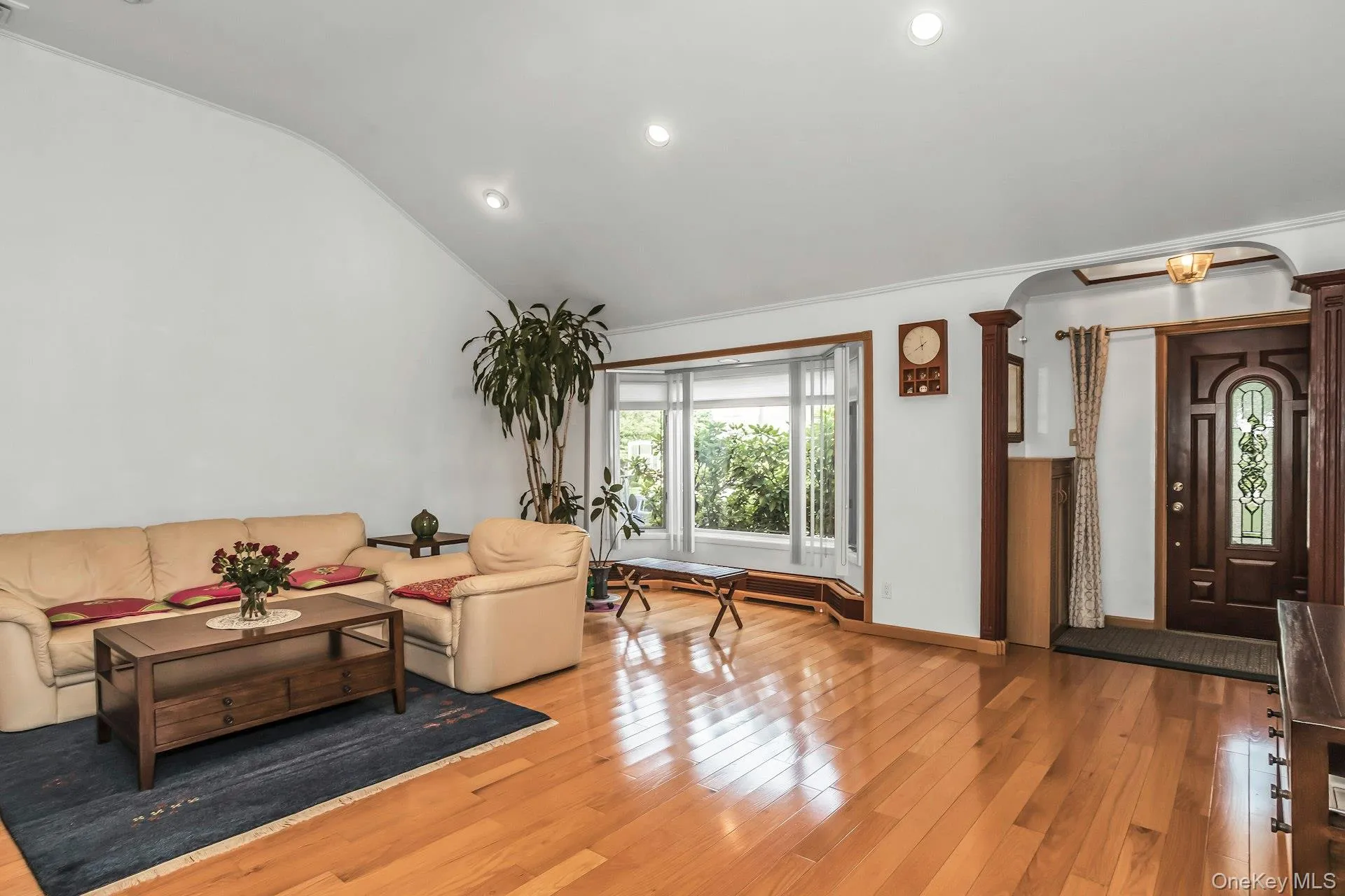 Living area with light wood-style flooring, recessed lighting, vaulted ceiling, crown molding Living area with light wood-style flooring, recessed lighting, vaulted ceiling, crown molding