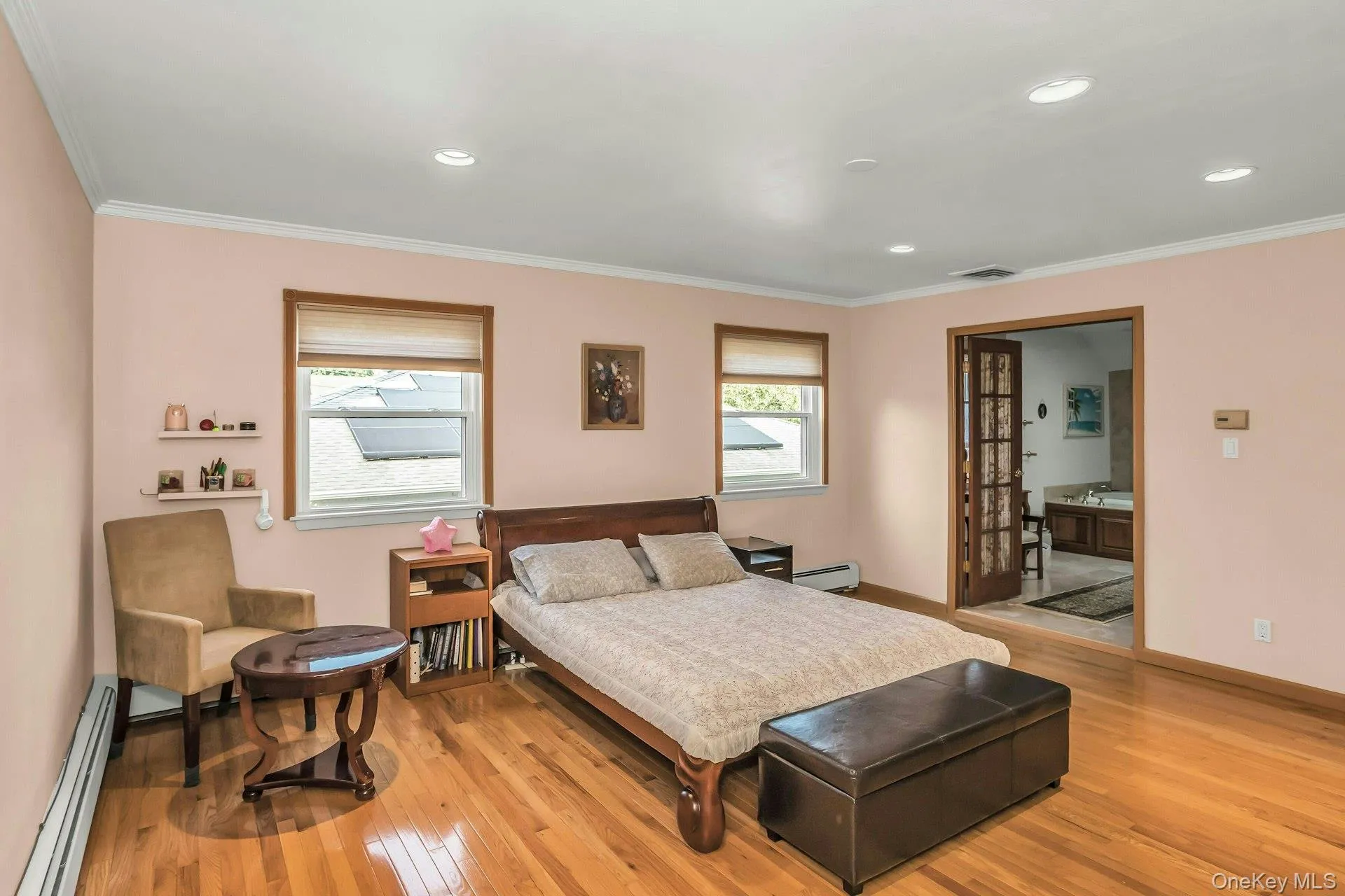 Primary Bedroom featuring crown molding, wood flooring and recessed lighting Primary Bedroom featuring crown molding, wood flooring and recessed lighting