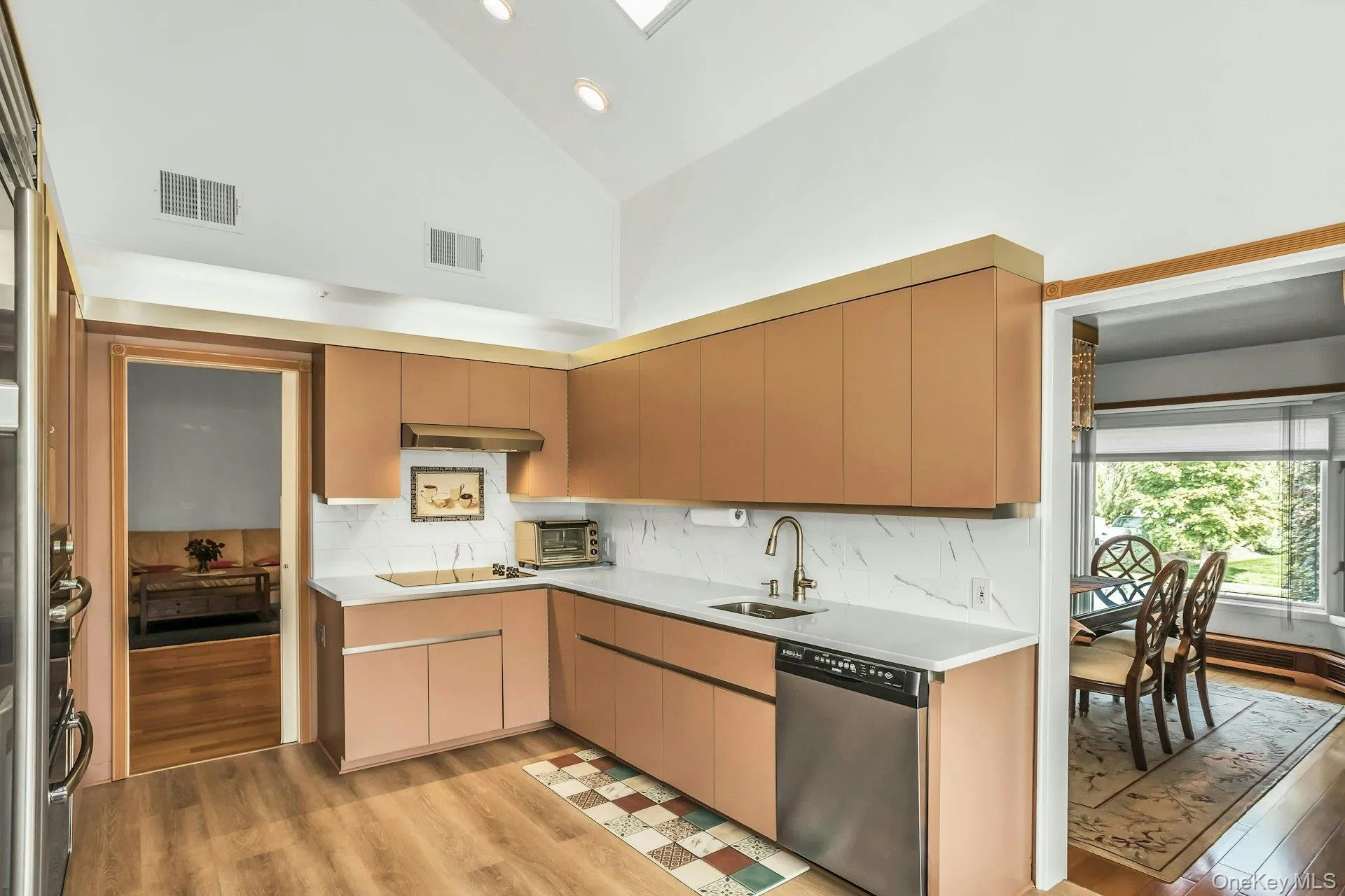 Eat in Kitchen with high vaulted ceiling, light wood-style floors, dishwasher, backsplash, and recessed lighting Eat in Kitchen with high vaulted ceiling, light wood-style floors, dishwasher, backsplash, and recessed lighting