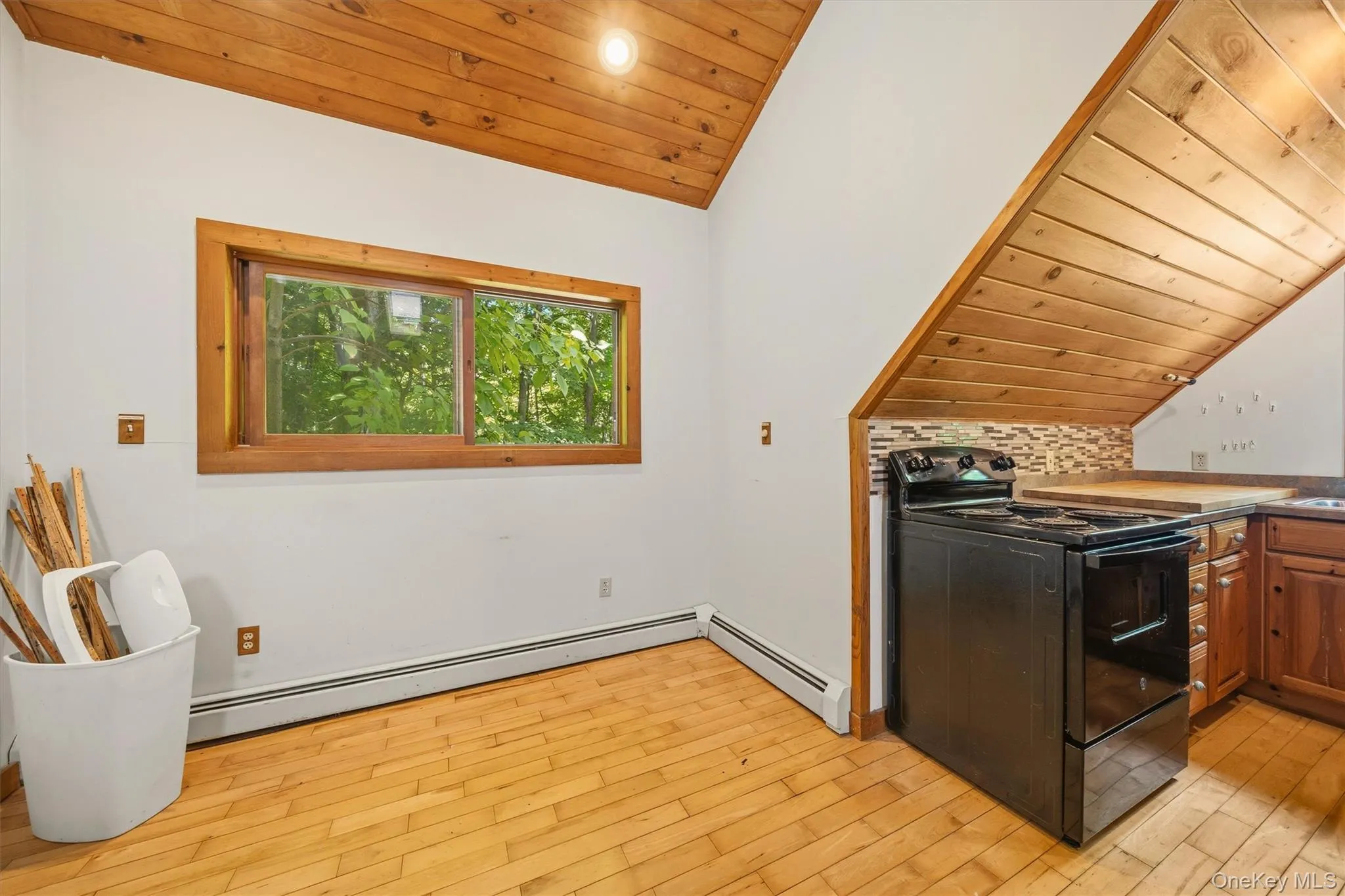 Kitchenette featuring wood-finish flooring and a wood plank ceiling Kitchenette featuring wood-finish flooring and a wood plank ceiling