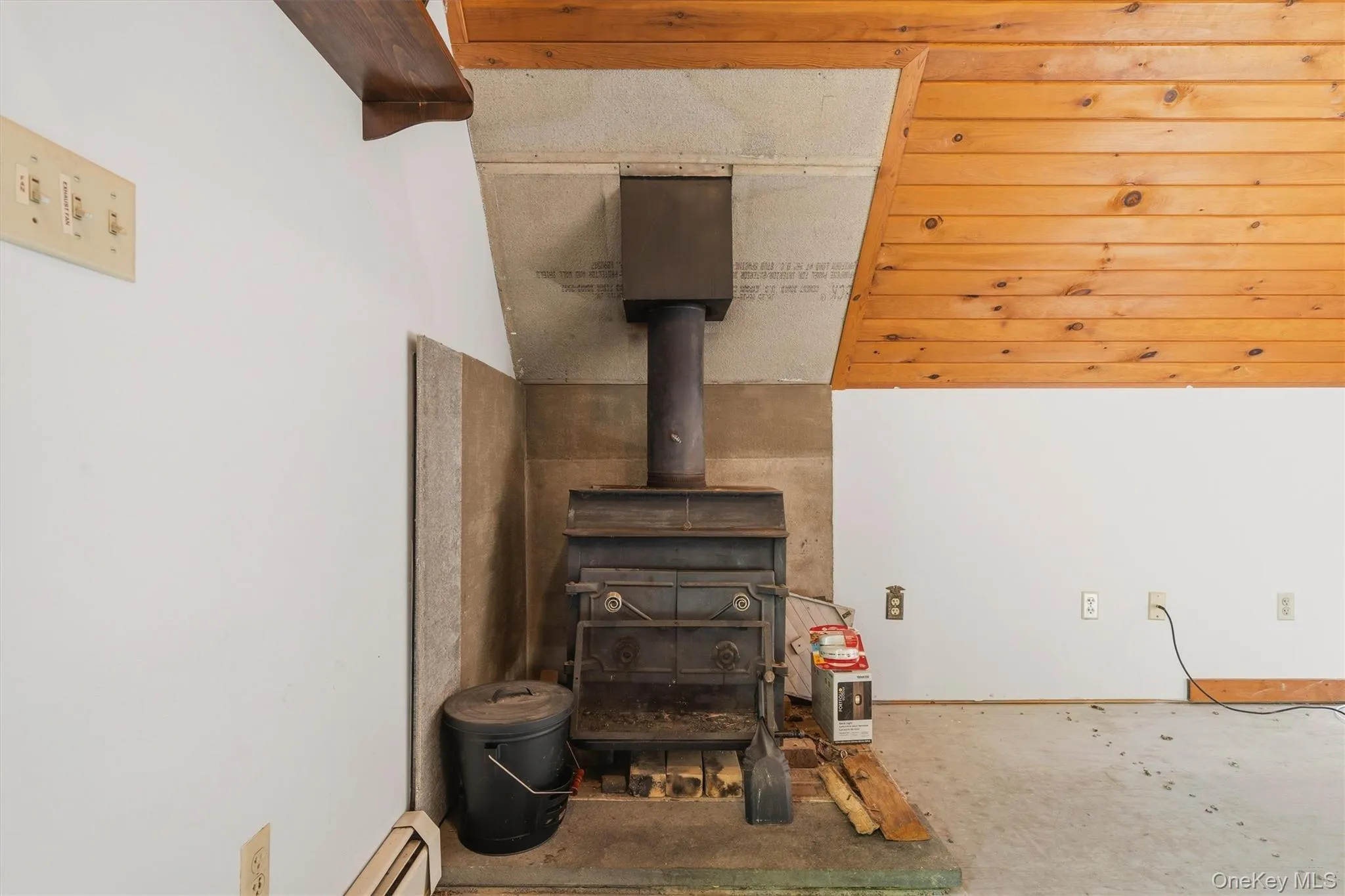 Freestanding wood-burning stove with a stone surround and hearth Freestanding wood-burning stove with a stone surround and hearth