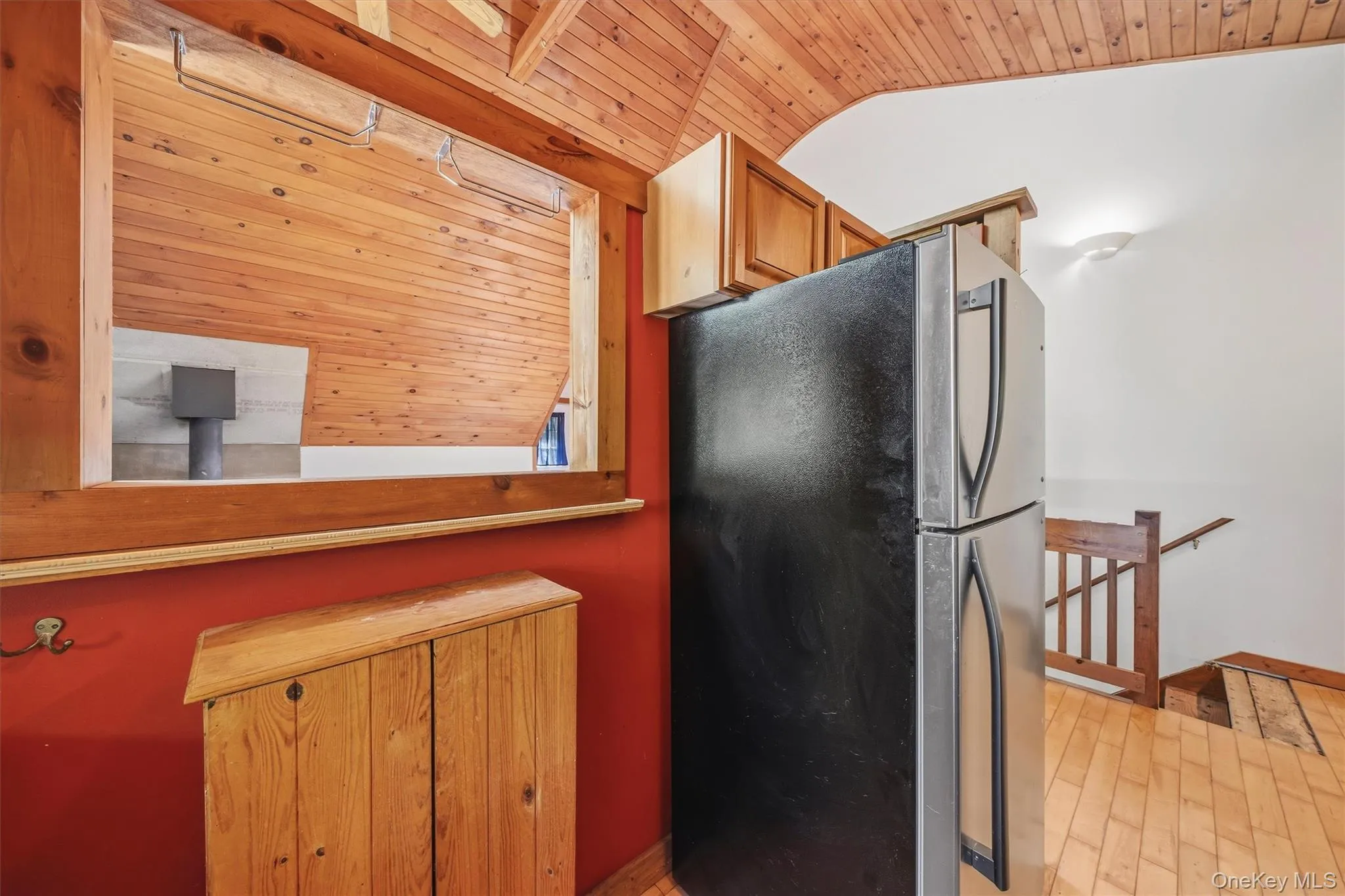 Wood-paneled ceilings and walls complement a pass-through window with a natural wood frame Wood-paneled ceilings and walls complement a pass-through window with a natural wood frame
