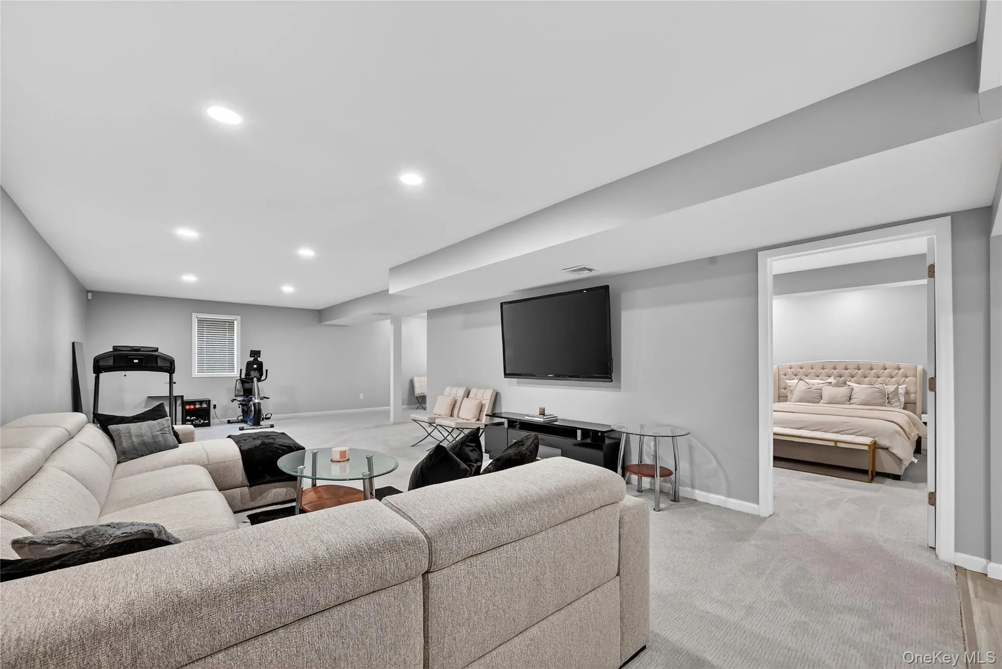 Spacious room featuring light-colored carpeting, recessed lighting, and a neutral wall color Spacious room featuring light-colored carpeting, recessed lighting, and a neutral wall color