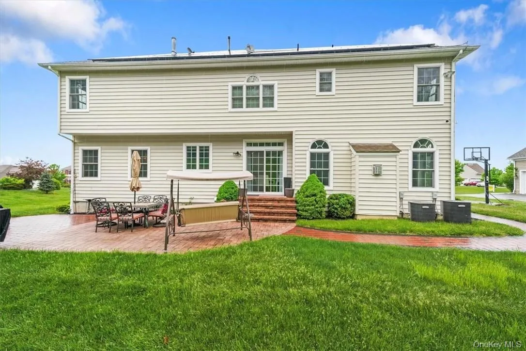 Rear view of property featuring a patio area, central air condition unit, and a yard Rear view of property featuring a patio area, central air condition unit, and a yard