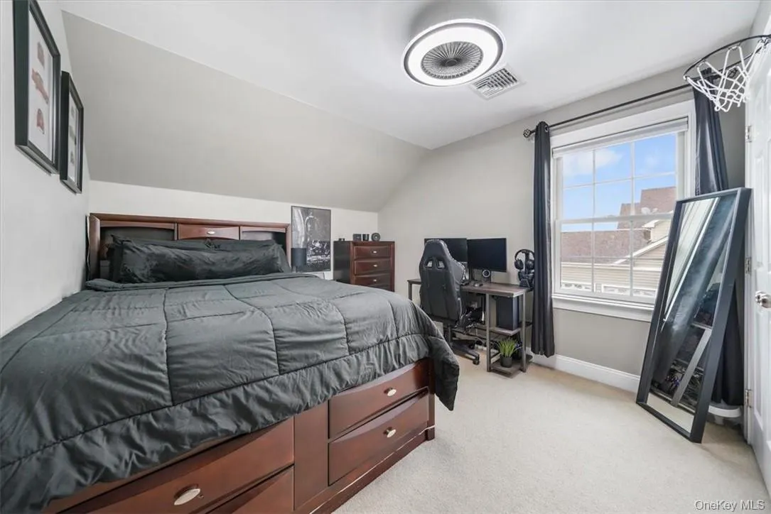 Carpeted bedroom with lofted ceiling Carpeted bedroom with lofted ceiling