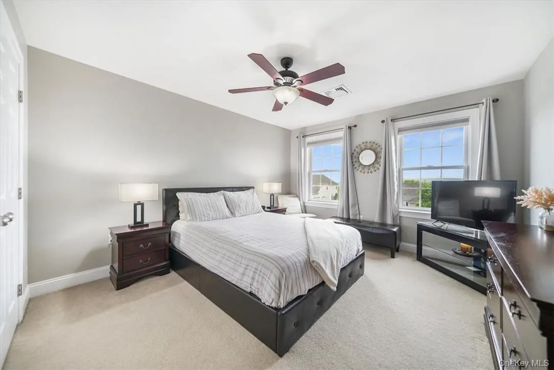 Carpeted bedroom with ceiling fan Carpeted bedroom with ceiling fan