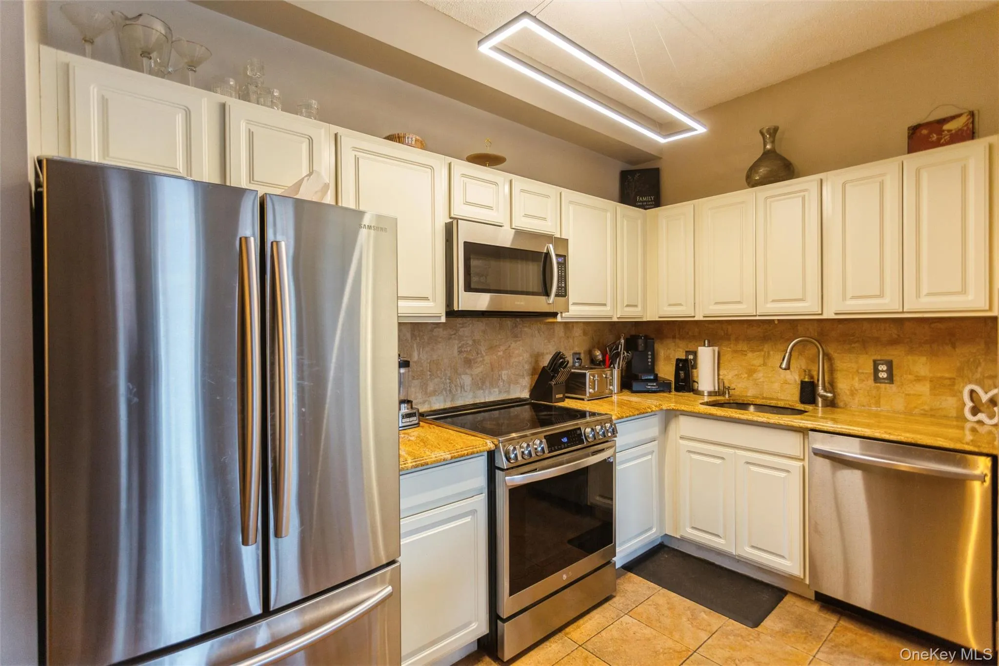 Updated kitchen featuring stainless steel appliances, ample cabinetry, and generous counter space. Updated kitchen featuring stainless steel appliances, ample cabinetry, and generous counter space.