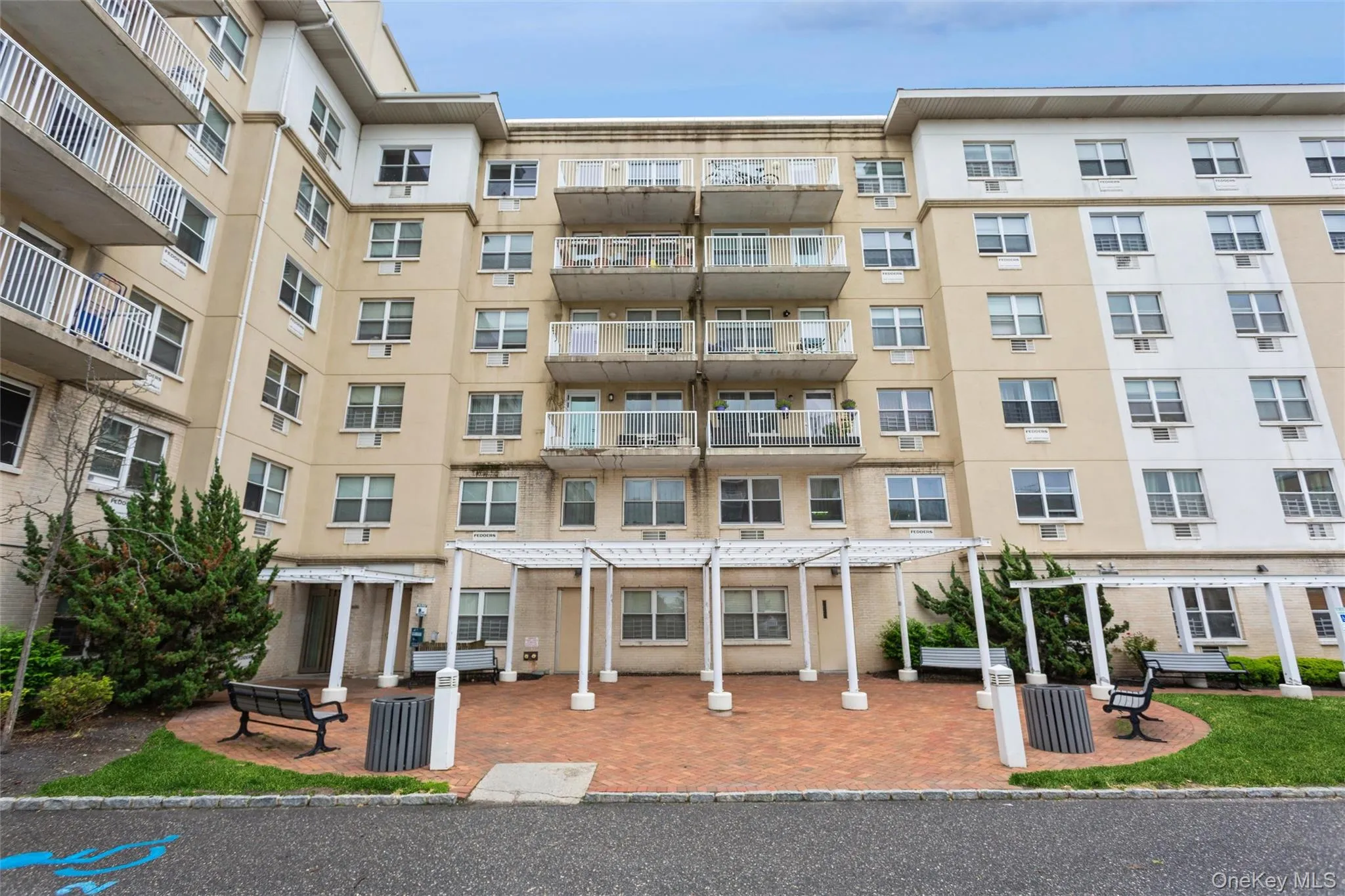 Spacious outdoor common area featuring seating, landscaped surroundings, and access to the building's private courtyard. Spacious outdoor common area featuring seating, landscaped surroundings, and access to the building's private courtyard.