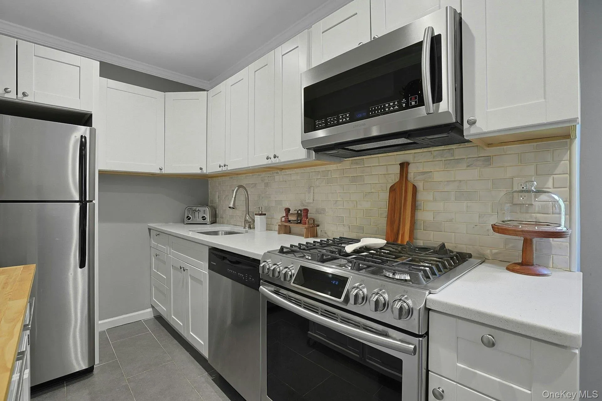 Stainless Appliances, Quartz Counters And Custom Backsplash Stainless Appliances, Quartz Counters And Custom Backsplash