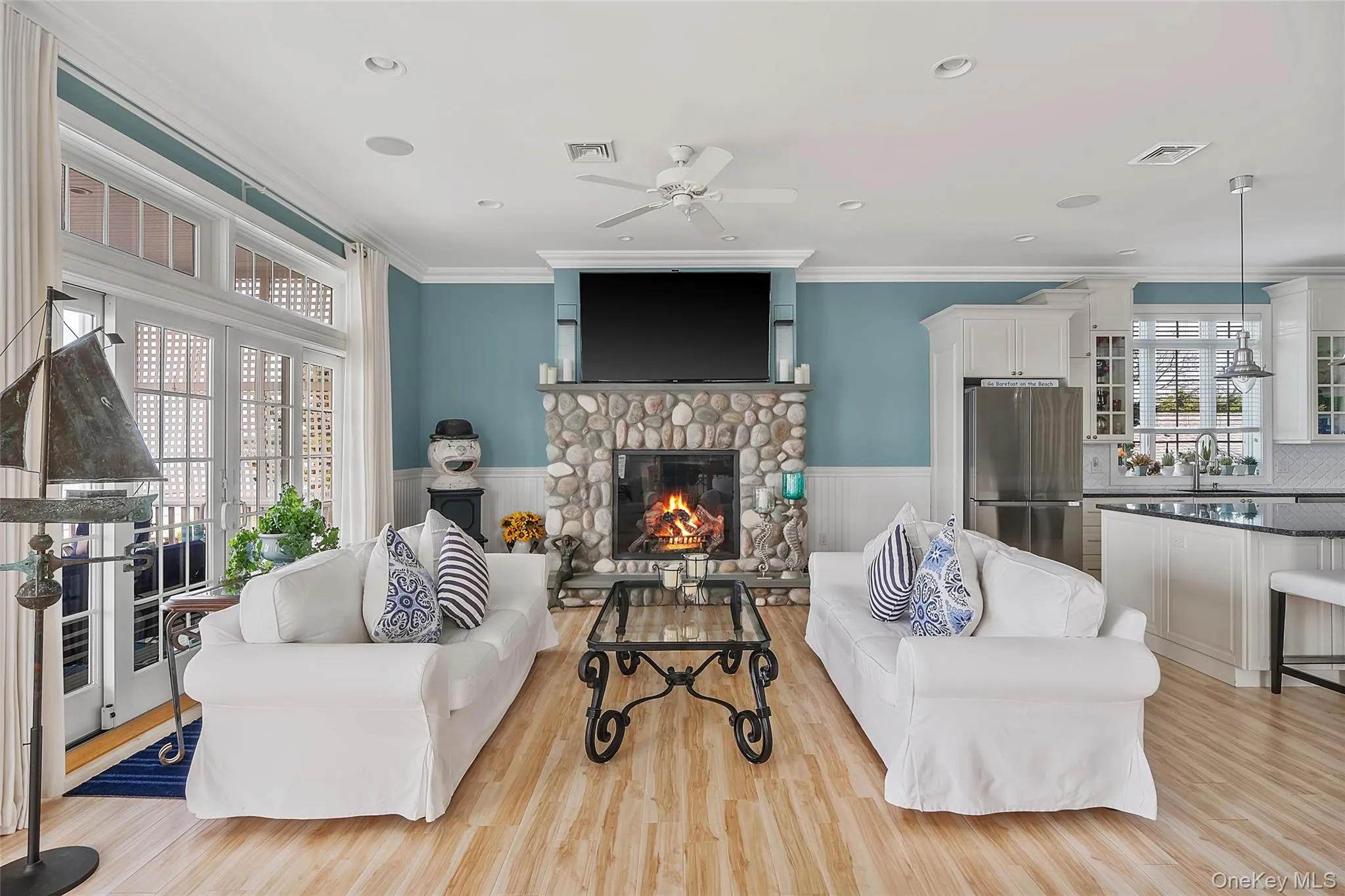 Open-concept living space with wood-finish flooring Open-concept living space with wood-finish flooring