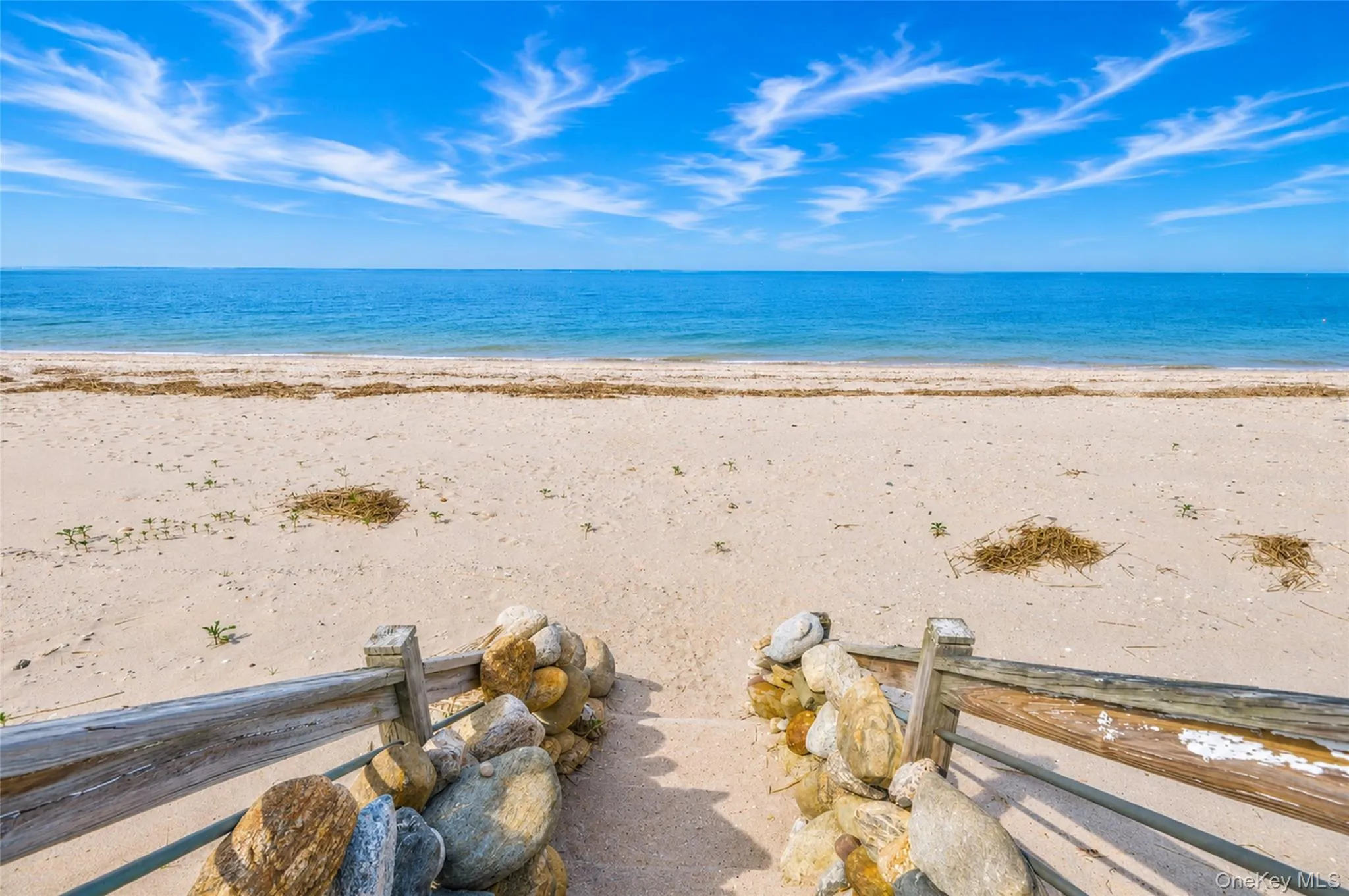 Beachfront property featuring a sandy shore and direct water access Beachfront property featuring a sandy shore and direct water access