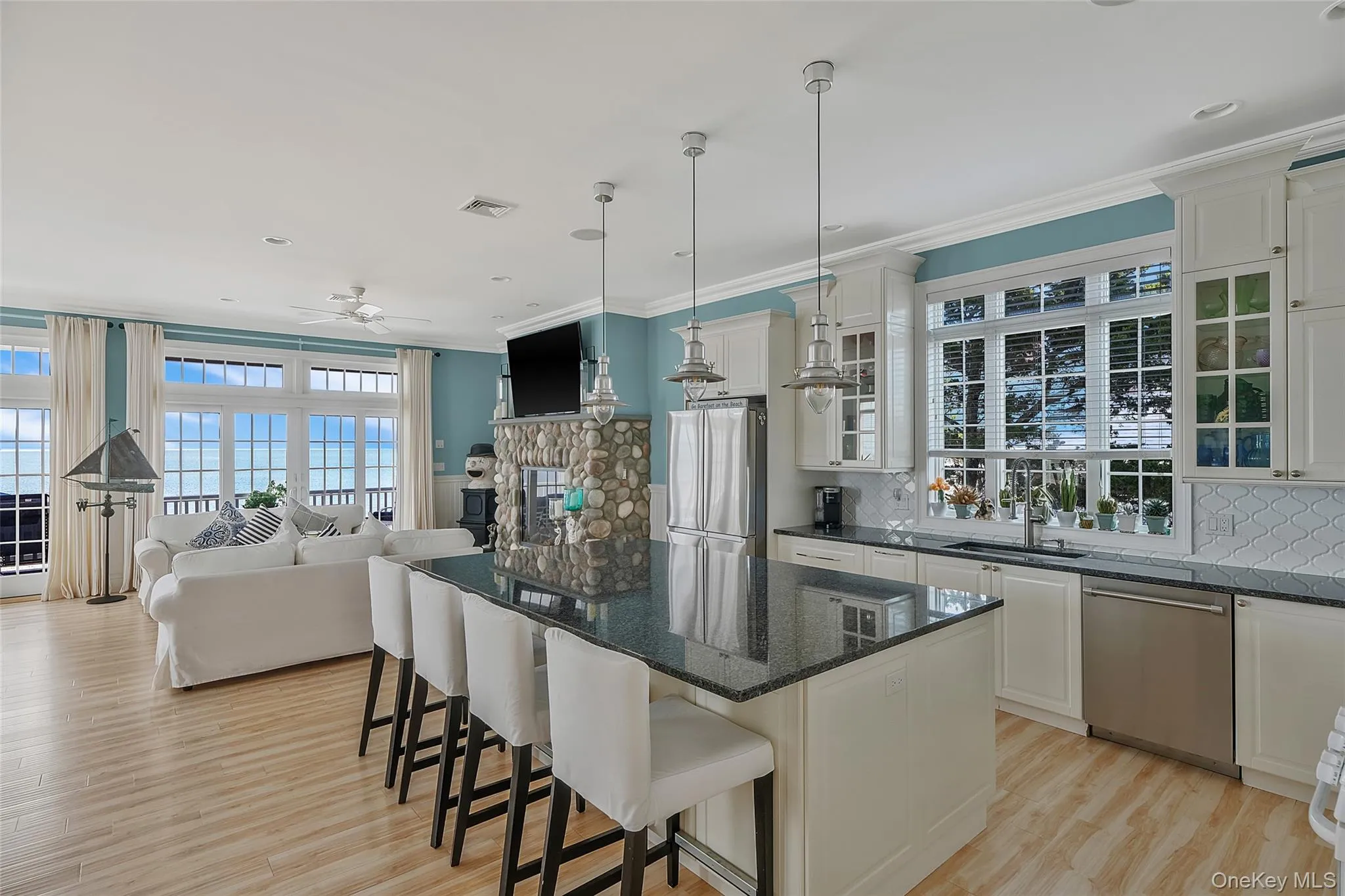Open-concept living space with wood-finish flooring Open-concept living space with wood-finish flooring
