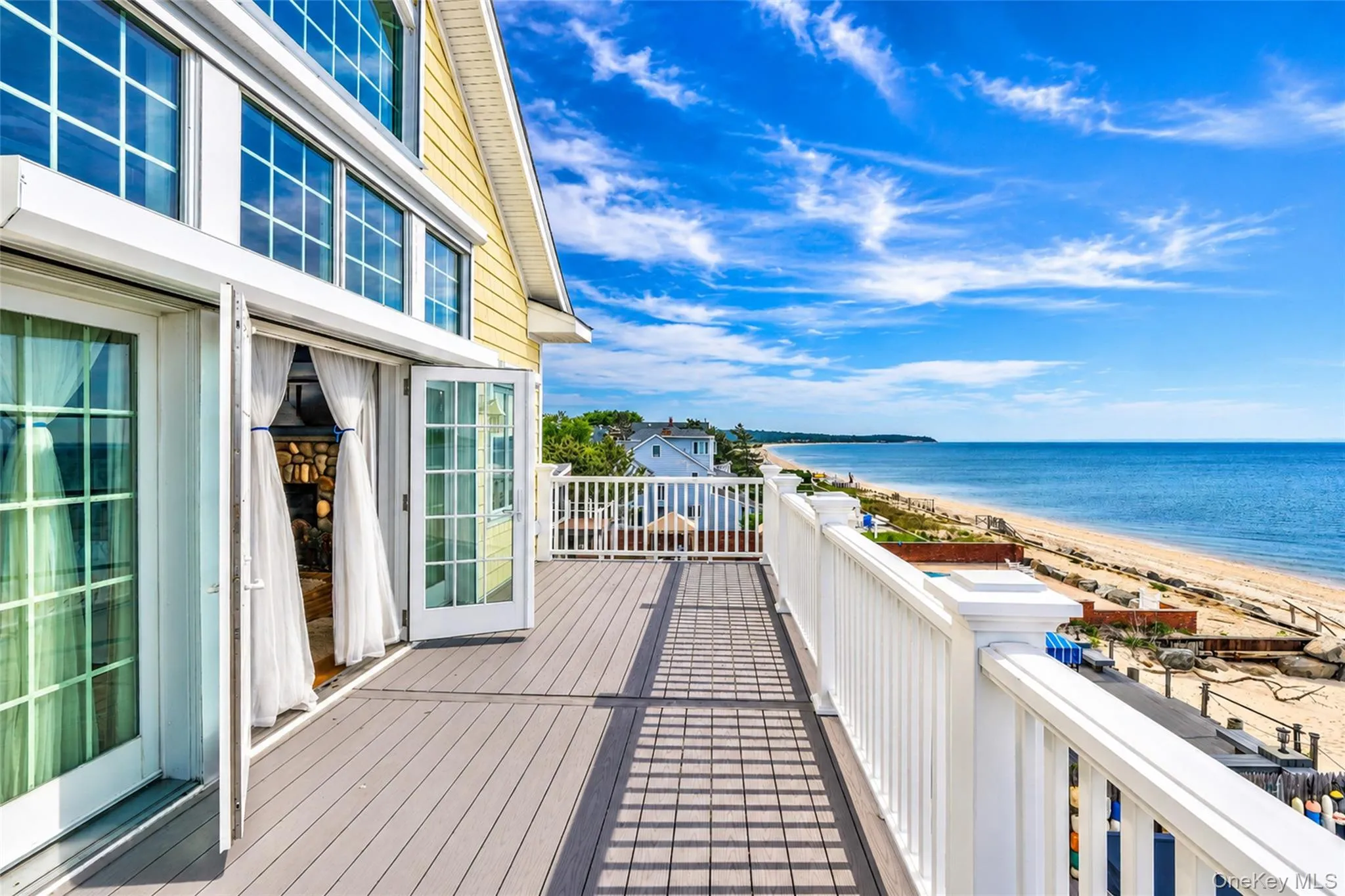 Expansive outdoor deck featuring composite Procell decking and white railings Expansive outdoor deck featuring composite Procell decking and white railings