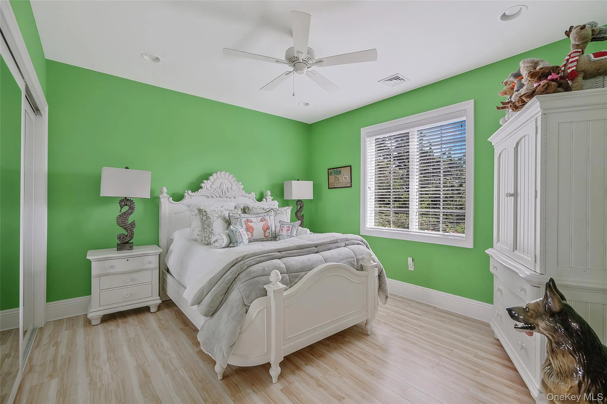 Bright interior space featuring a window with horizontal blinds, wood-finish flooring, a ceiling fan, and recessed lighting Bright interior space featuring a window with horizontal blinds, wood-finish flooring, a ceiling fan, and recessed lighting