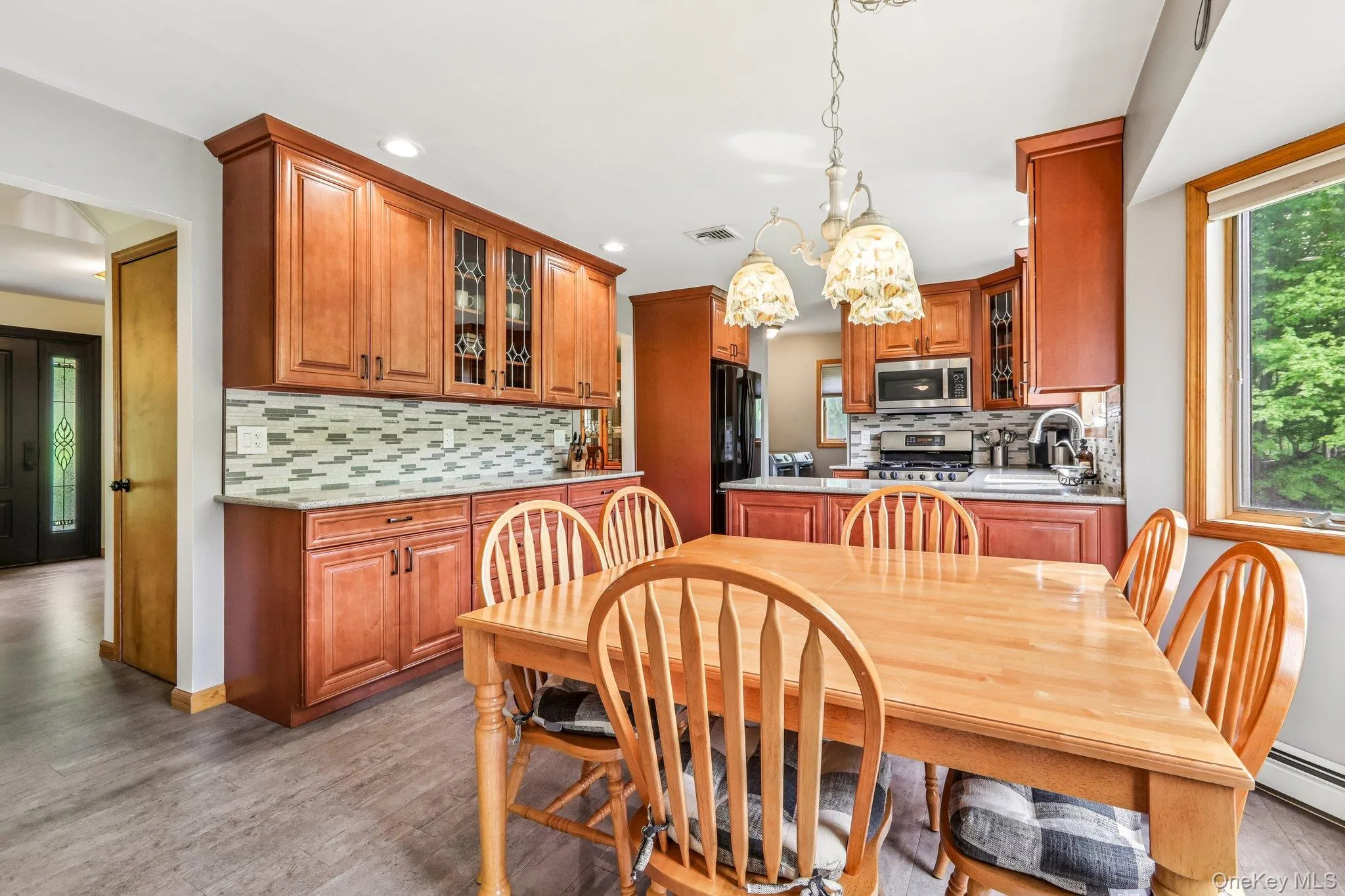 Kitchen has cherry finished cabinets, quartz countertops, and stainless steel appliances. Kitchen has cherry finished cabinets, quartz countertops, and stainless steel appliances.