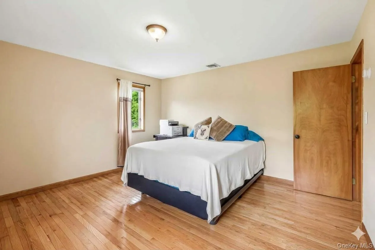 Large bedroom with closet and hardwood floors. Large bedroom with closet and hardwood floors.