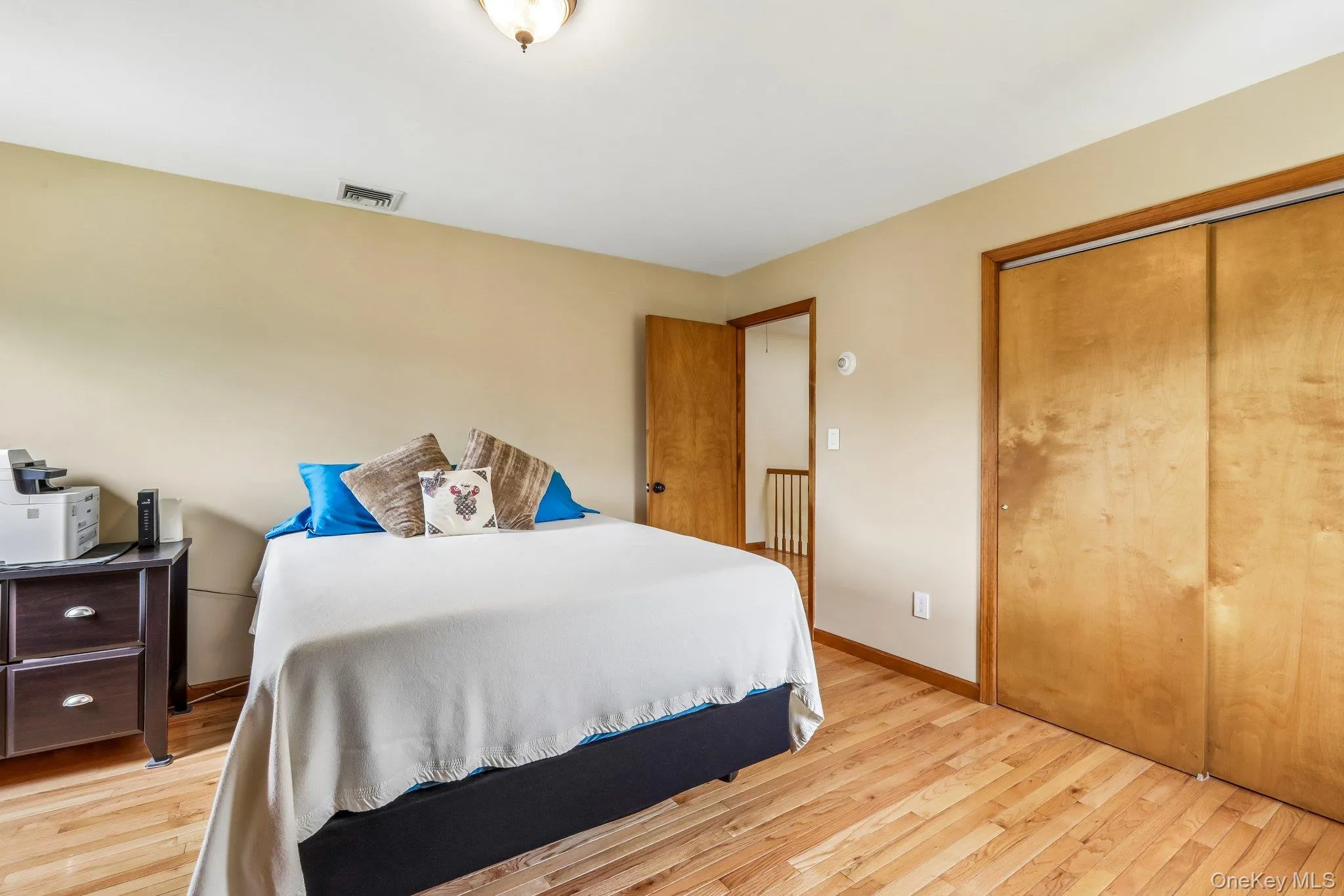 Large bedroom with closet and hardwood floors. Large bedroom with closet and hardwood floors.