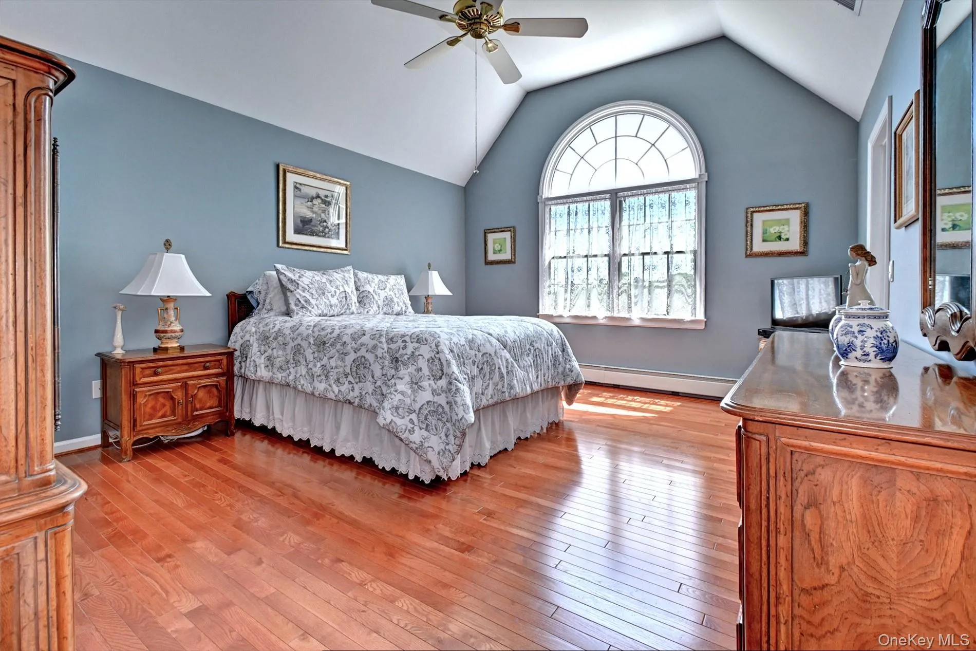 Primary Bedroom with Walk in Closet, Tray Ceiling and Half Moon Window Primary Bedroom with Walk in Closet, Tray Ceiling and Half Moon Window