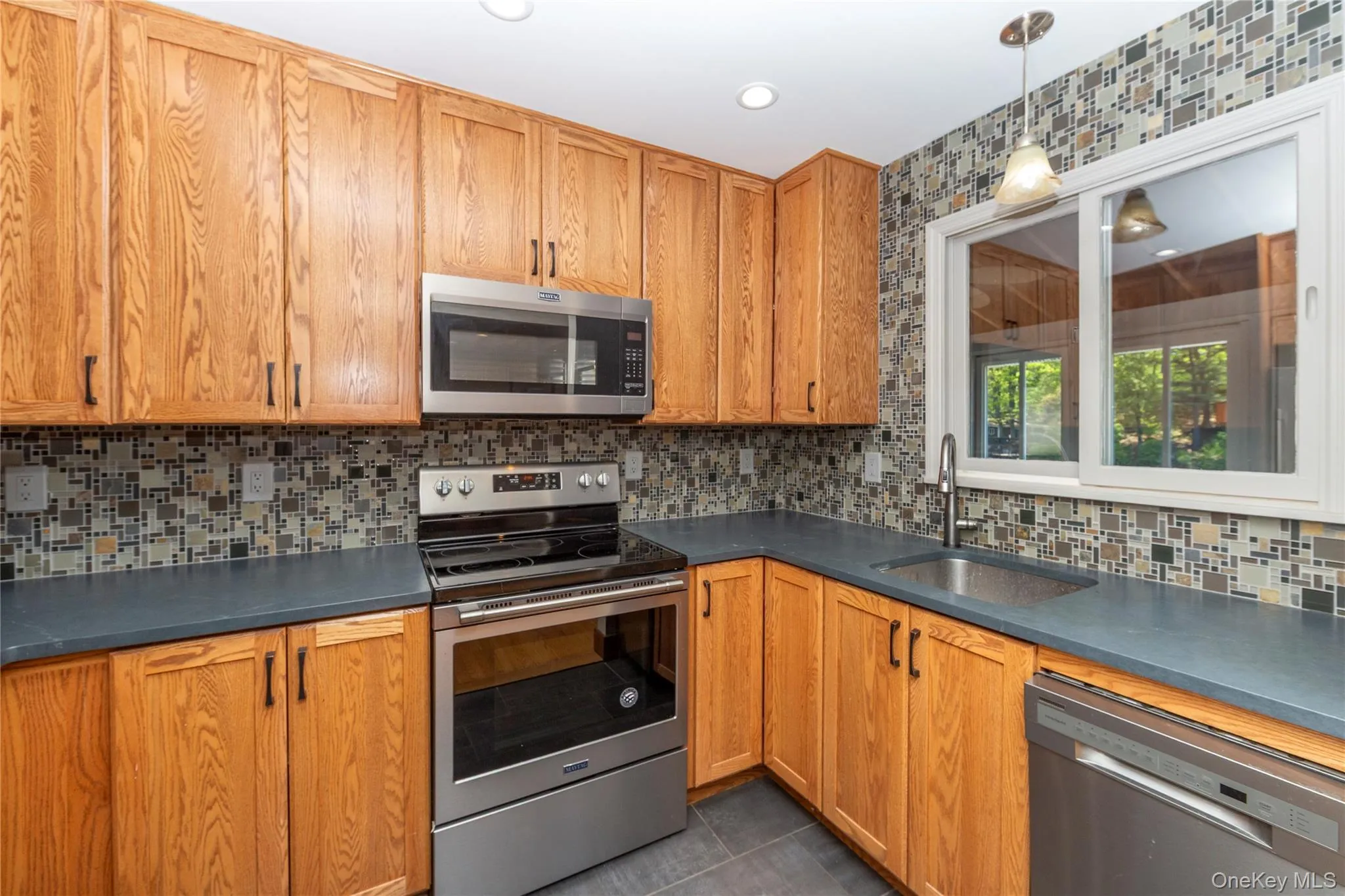 kitchen with view of range and microwave kitchen with view of range and microwave