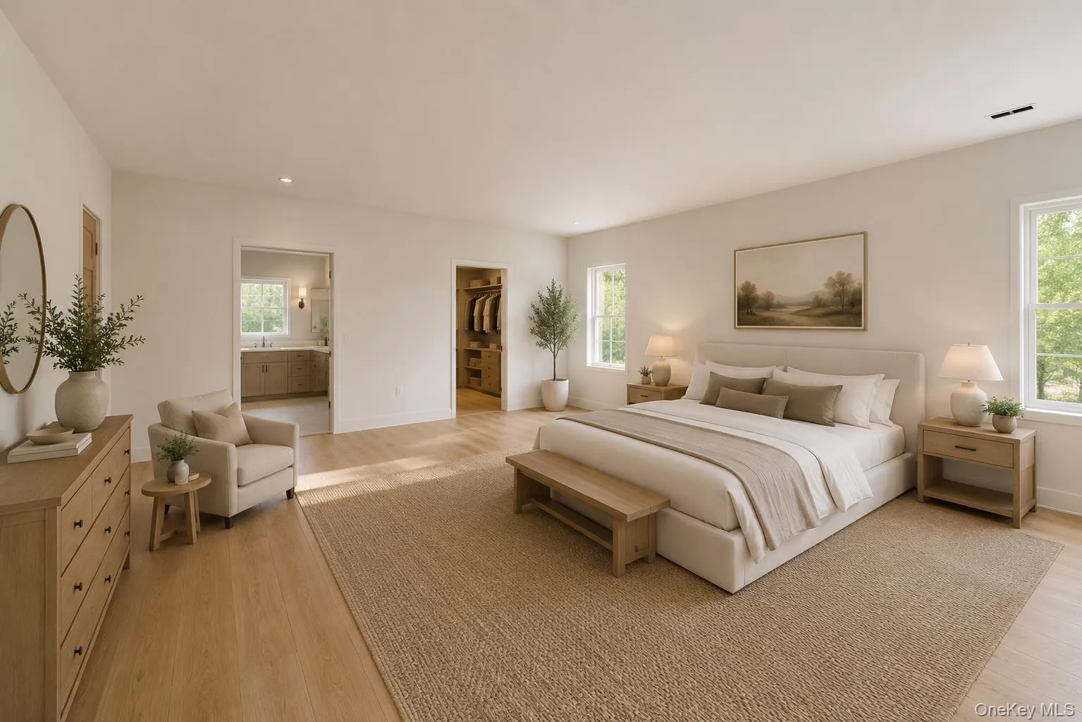 Expansive bedroom featuring light wood-finish flooring, recessed lighting, and multiple windows Expansive bedroom featuring light wood-finish flooring, recessed lighting, and multiple windows