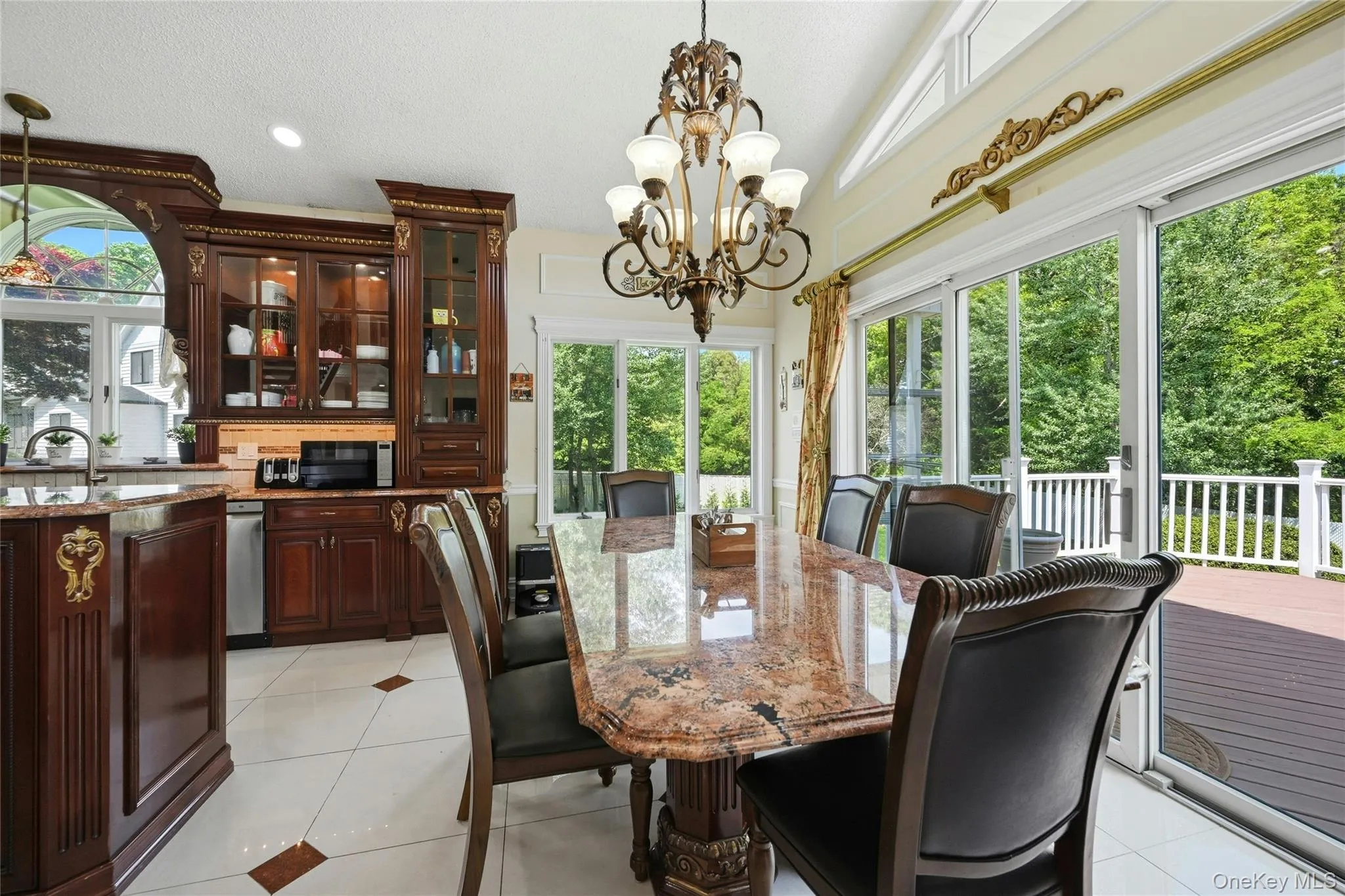 Dining area featuring a vaulted ceiling and a decorative chandelier Dining area featuring a vaulted ceiling and a decorative chandelier
