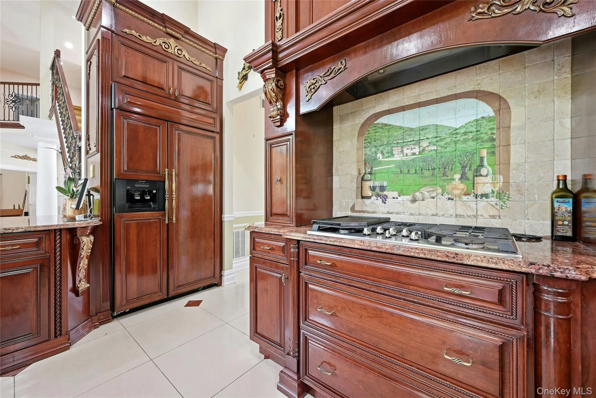 Custom wood cabinetry featuring ornate gold-tone accents Custom wood cabinetry featuring ornate gold-tone accents