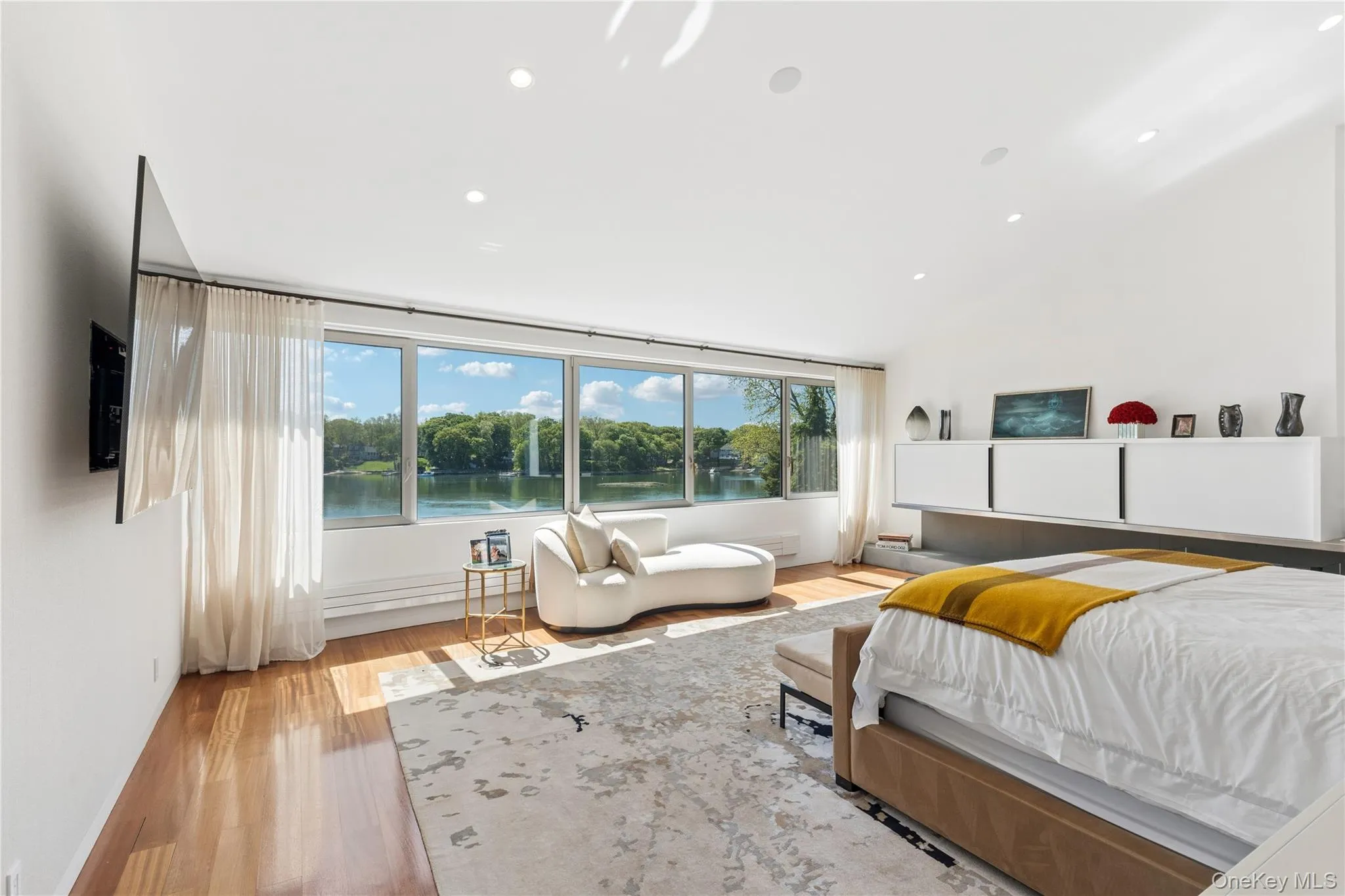Primary Bedroom w/ Water Views & Fireplace Primary Bedroom w/ Water Views & Fireplace